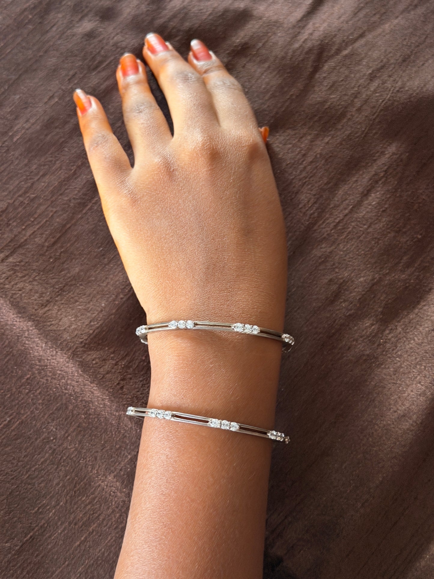 Silver bangles pair with white stone between 2 lines
