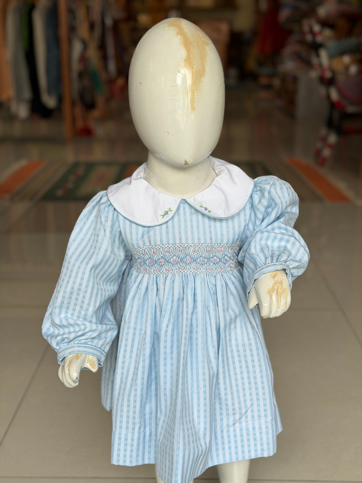 Pastel blue stripes smocking cotton frock for girls with embroidered Peter Pan collar and long sleeves