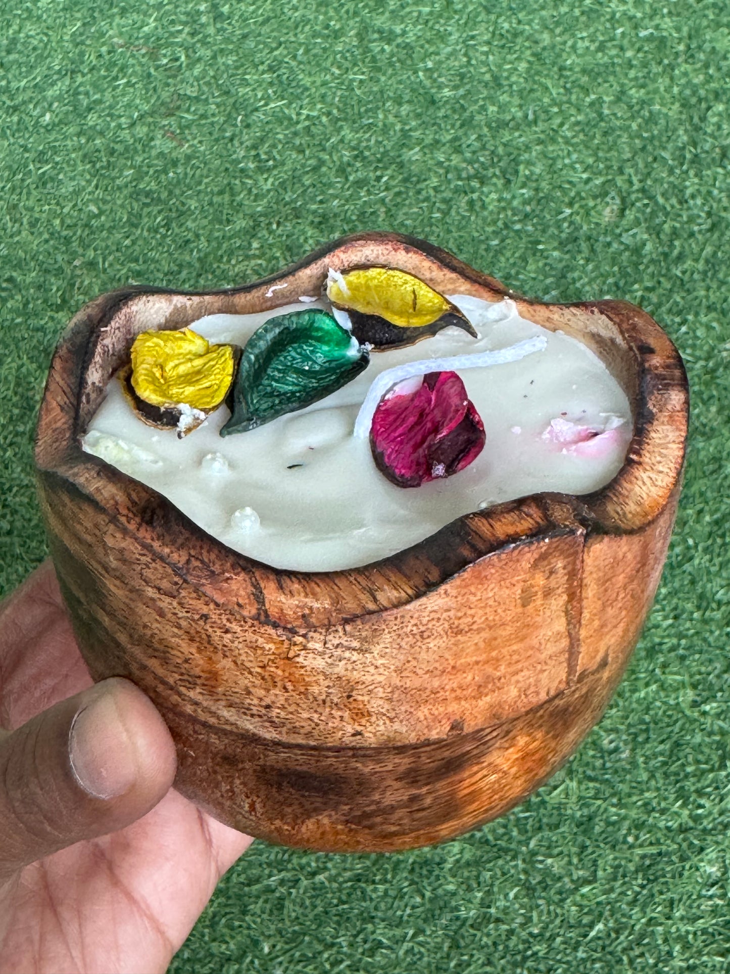 Candle in a flower shaped wooden bowl