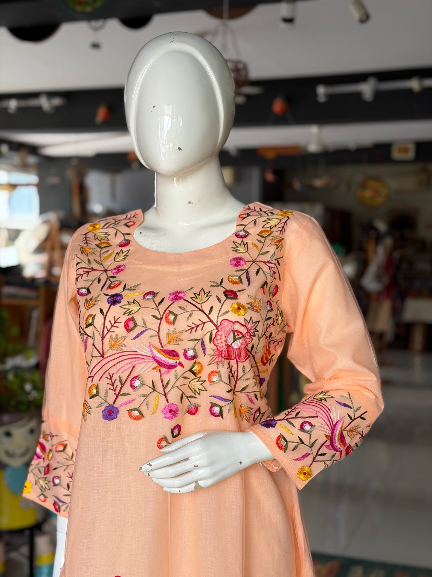 Peach hand embroidered birds and flowers design a-line net kurti with cotton lining