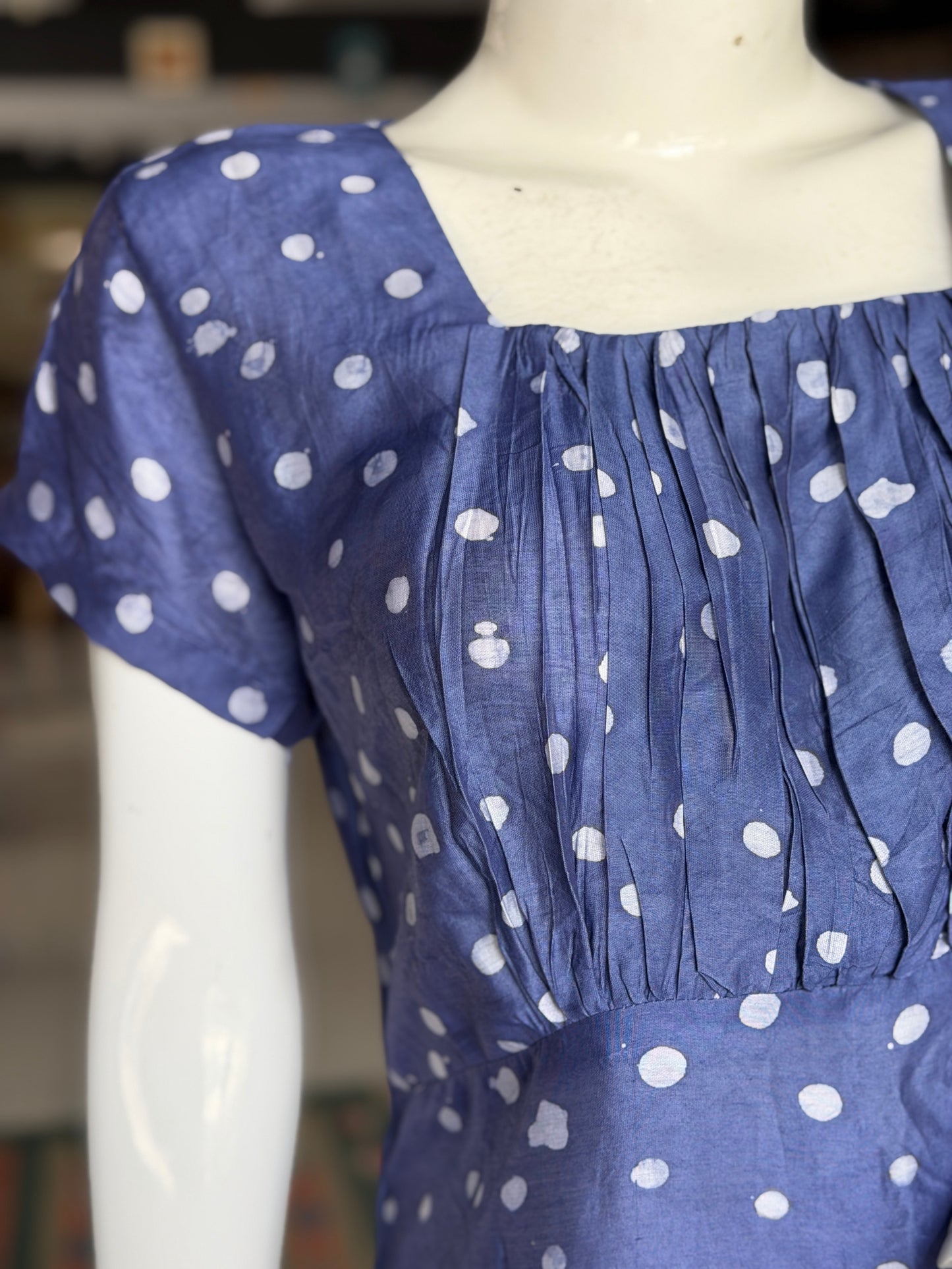 Blue polka dots dress with square neckline and gathered bust