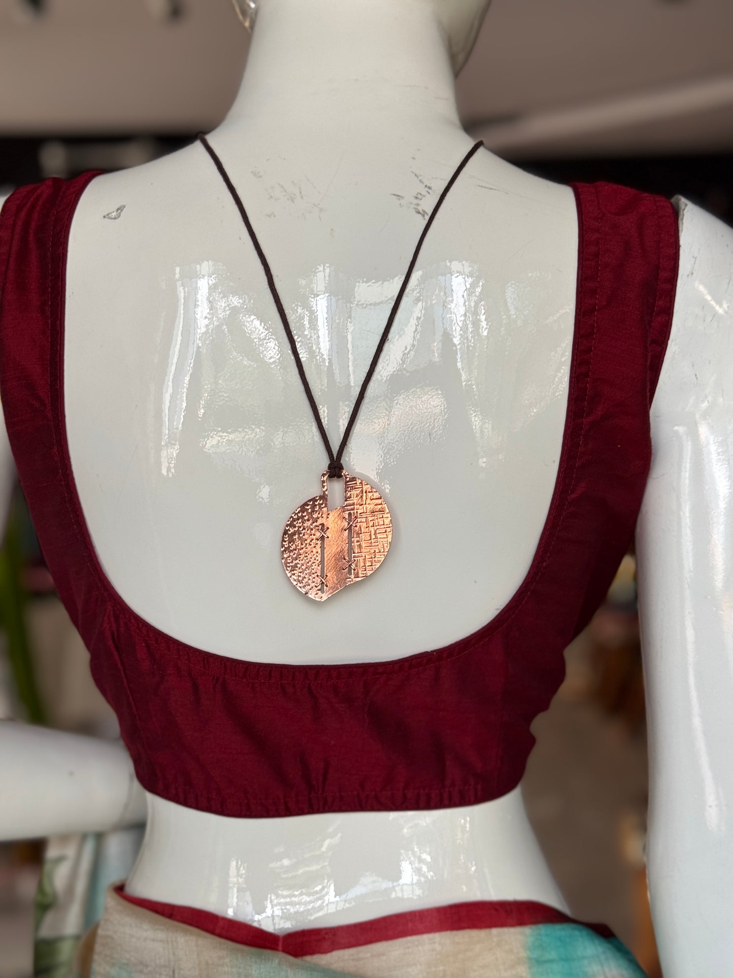 Handcrafted copper pendant with brown thread neck piece