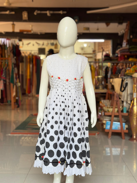 Black varying sized dots on white smocking cotton frock with hand embroidery and lace trims