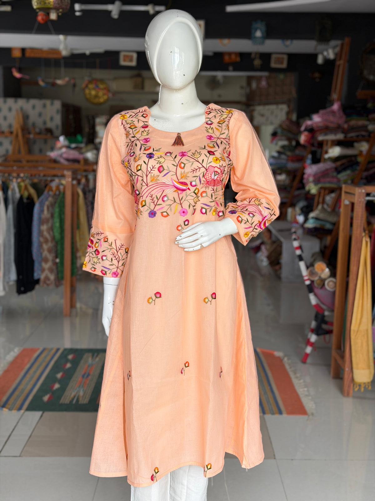 Peach hand embroidered birds and flowers design a-line net kurti with cotton lining