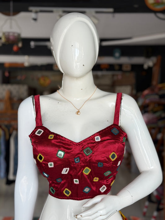 Maroon mashru sleeveless blouse with all over colorful mirror work on front and back
