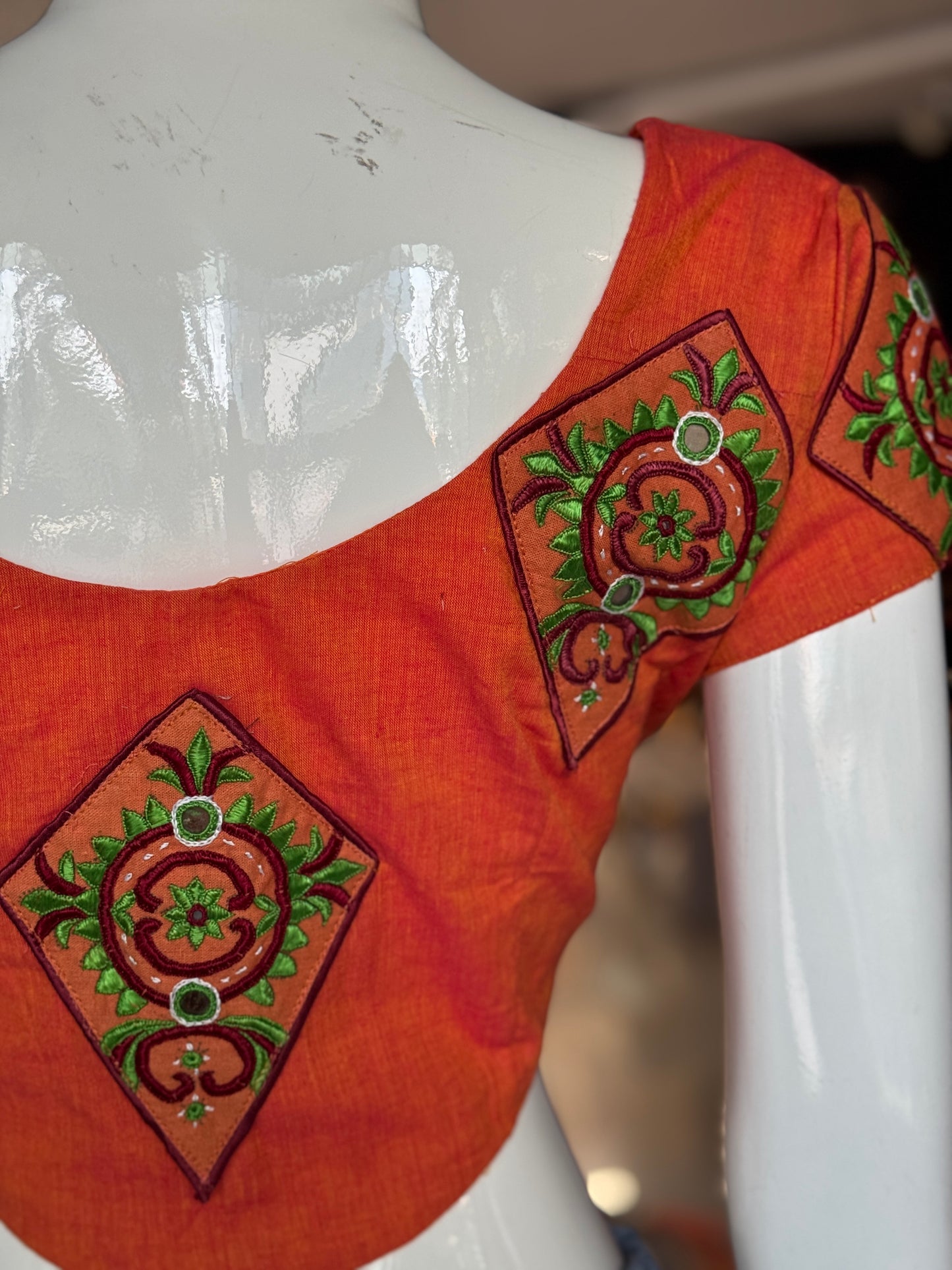 Orange cotton blouse with  embroidered patches on the back and sleeves