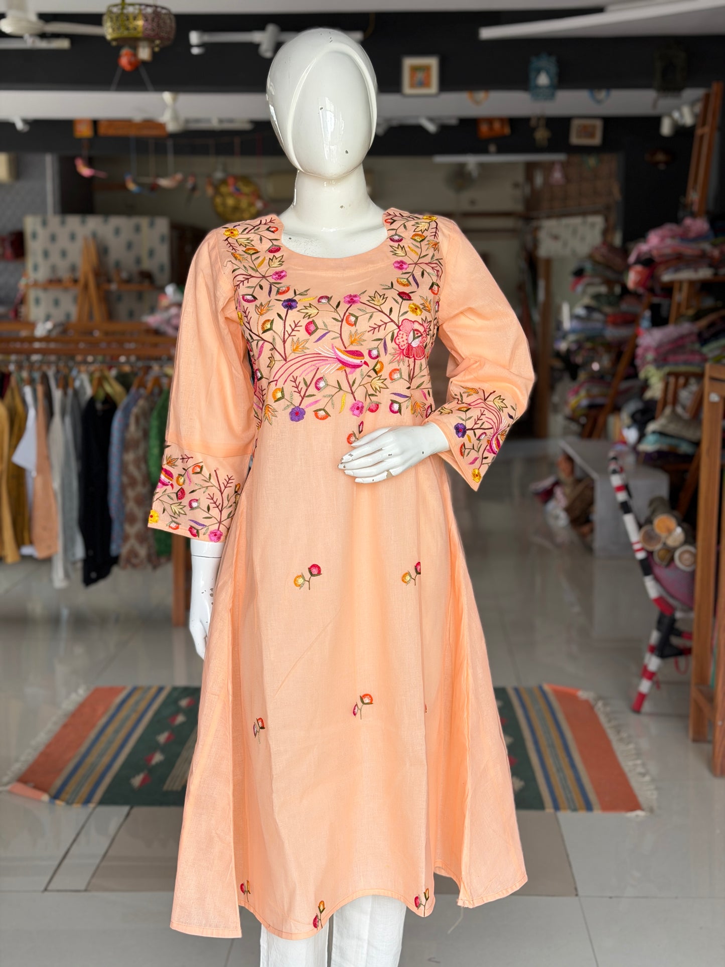 Peach hand embroidered birds and flowers design a-line net kurti with cotton lining