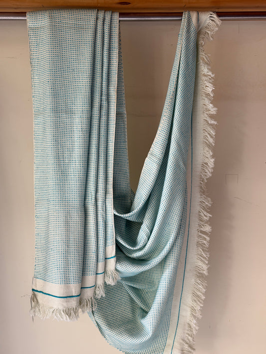 Off-white handwoven cotton sofa throw with blue woven stripes all over