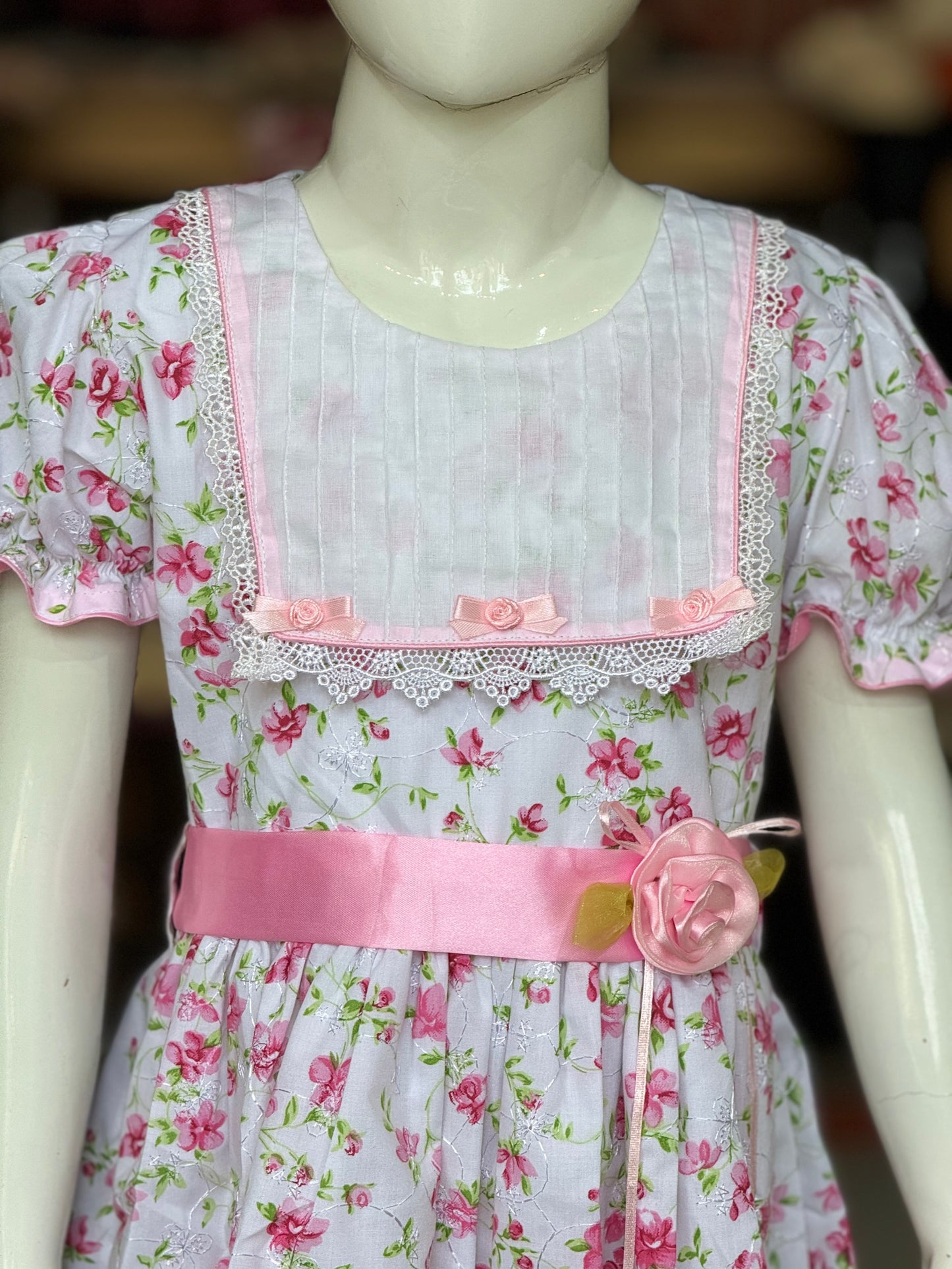 White and pink flowers print schifli cotton frock with ribbon flowers detailing at waist