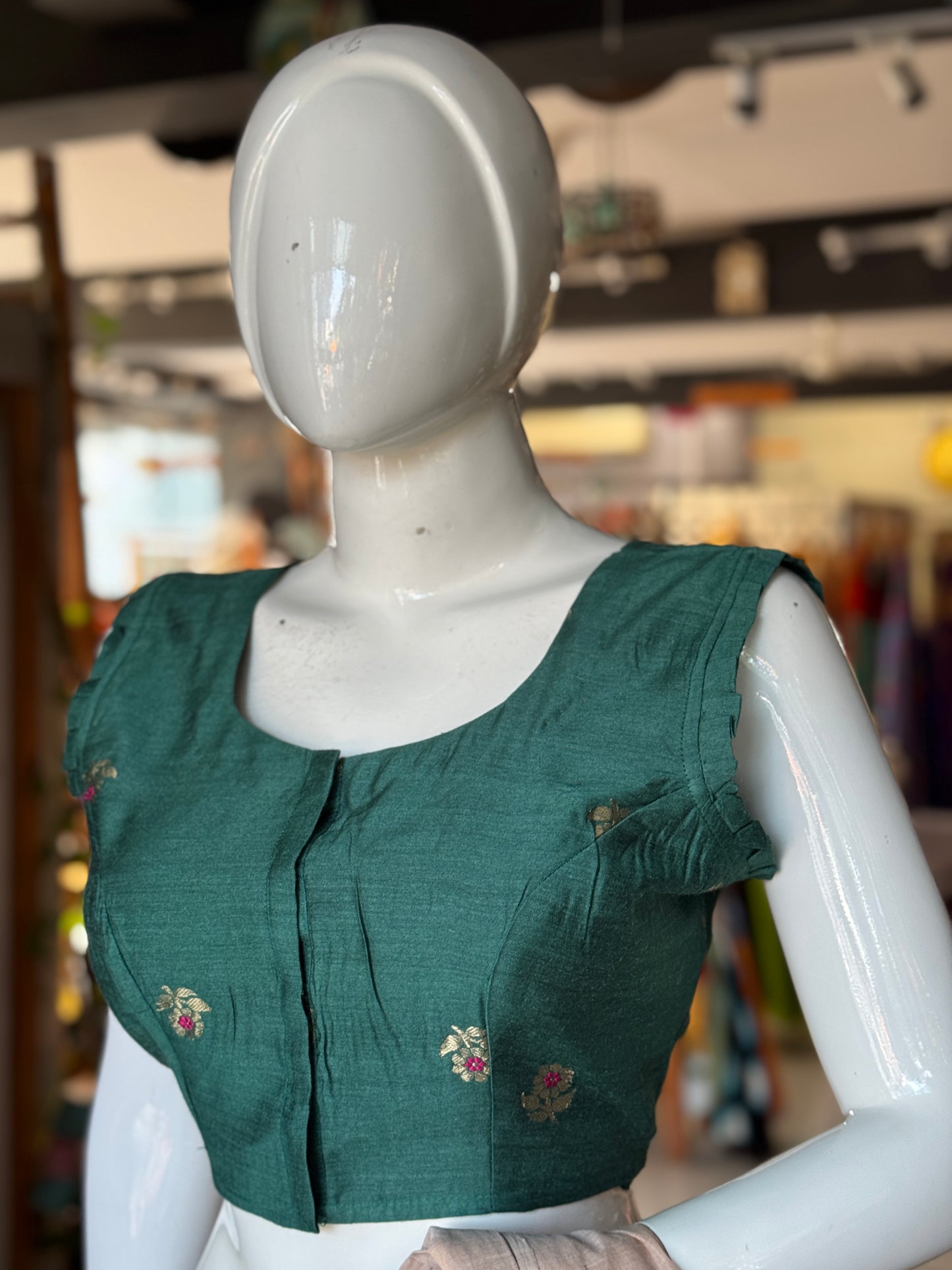 Teal green moonga silk handwoven blouse with floral motifs