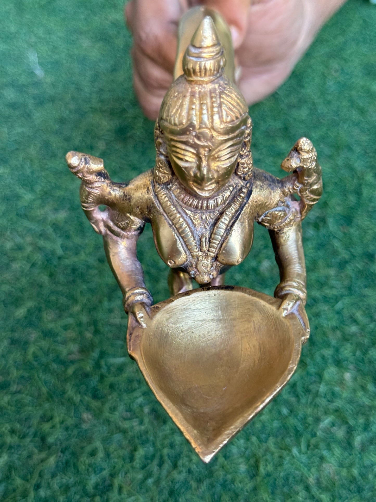 Lady holding Diya with long mermaid handle - handcrafted in brass