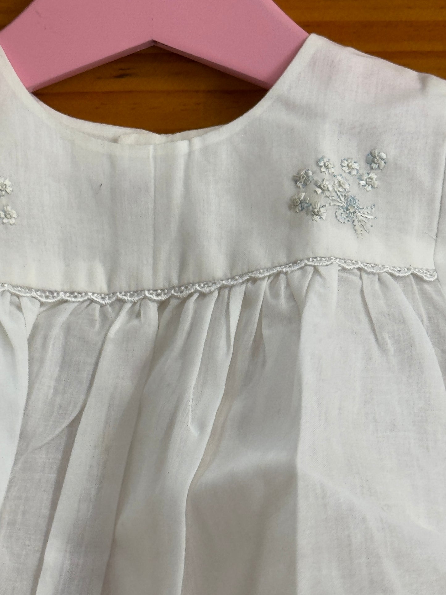 White cotton baby frock with cute flower bunch hand embroidery and lace trims