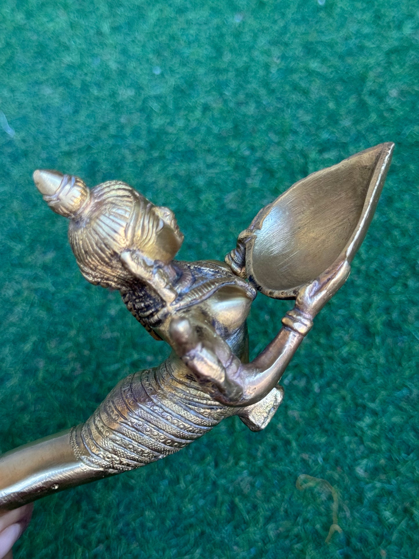 Lady holding Diya with long mermaid handle - handcrafted in brass