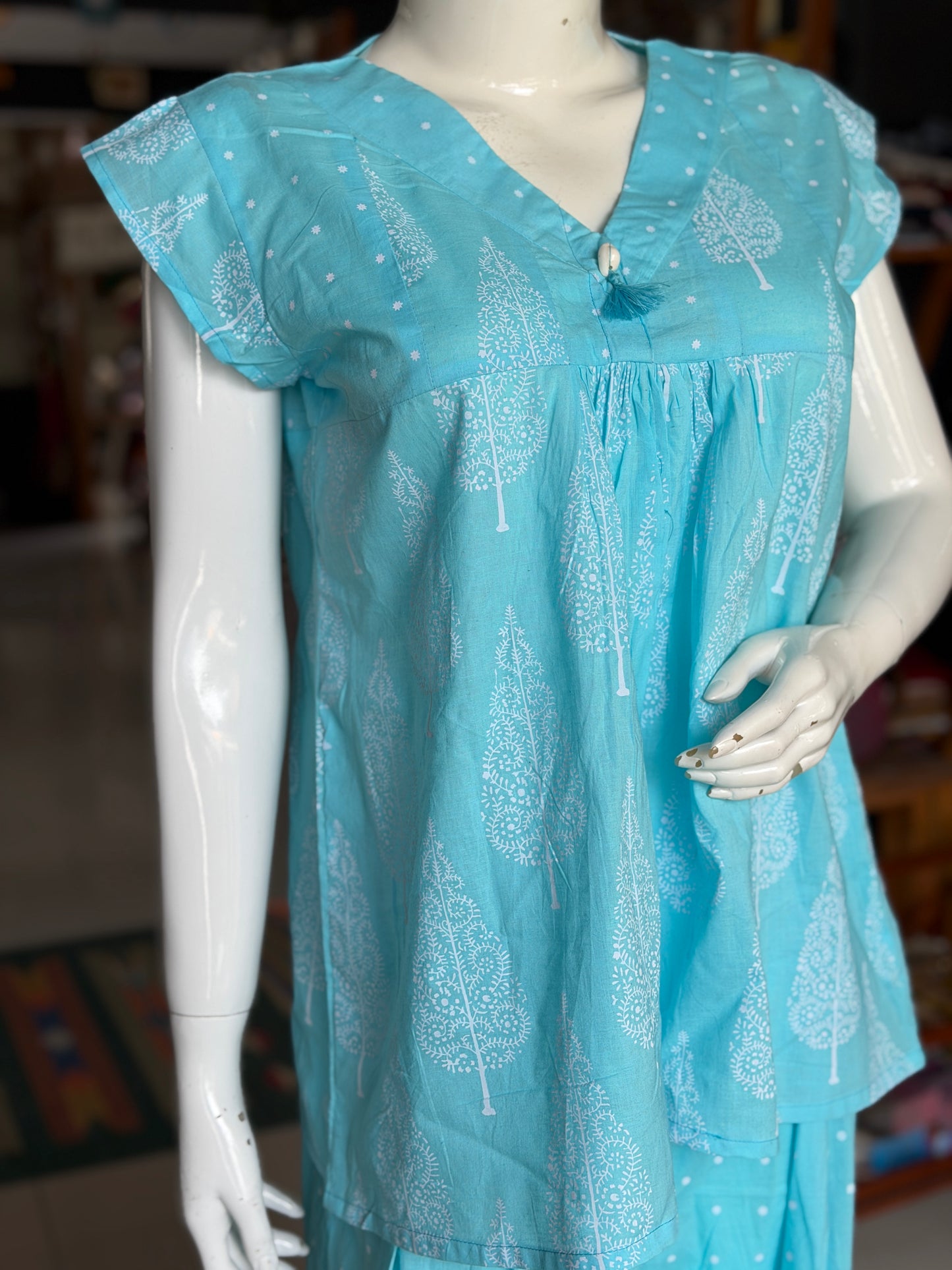 Blue dots and cypress print pleated cotton top with cowrie shell button