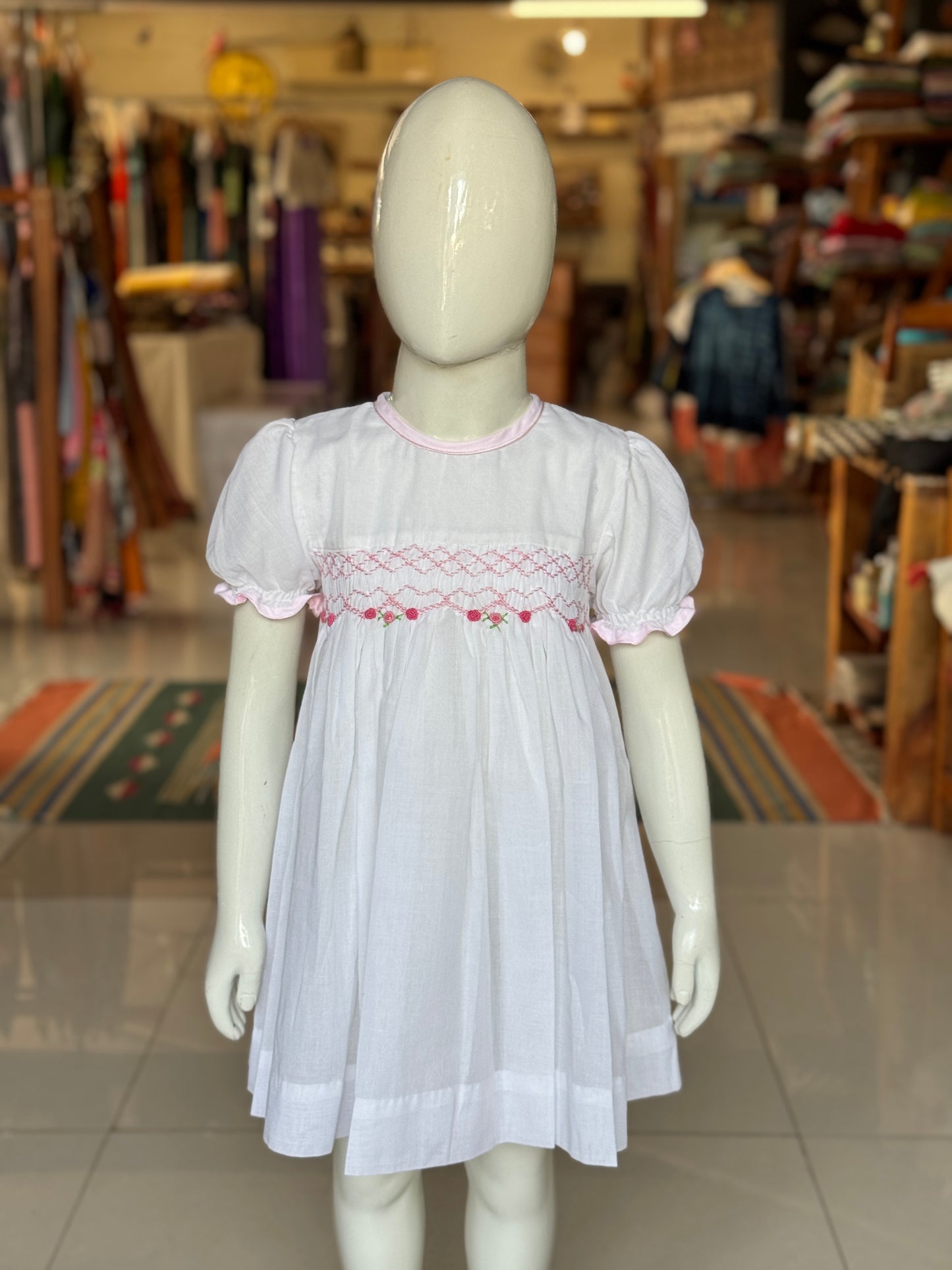White hand embroidered smocking cotton frock for girls with pink trims
