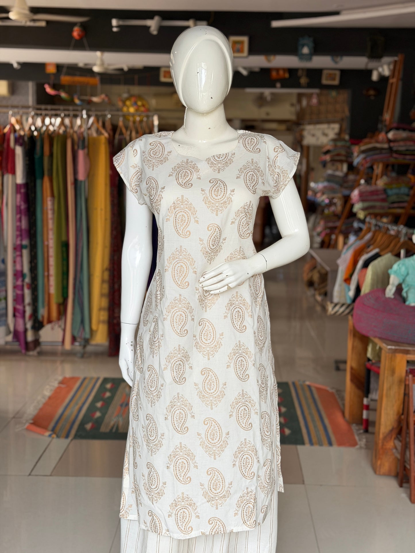 Off white paisley print cotton kurti paired with a matching stripes print barrel pants - 2 piece set