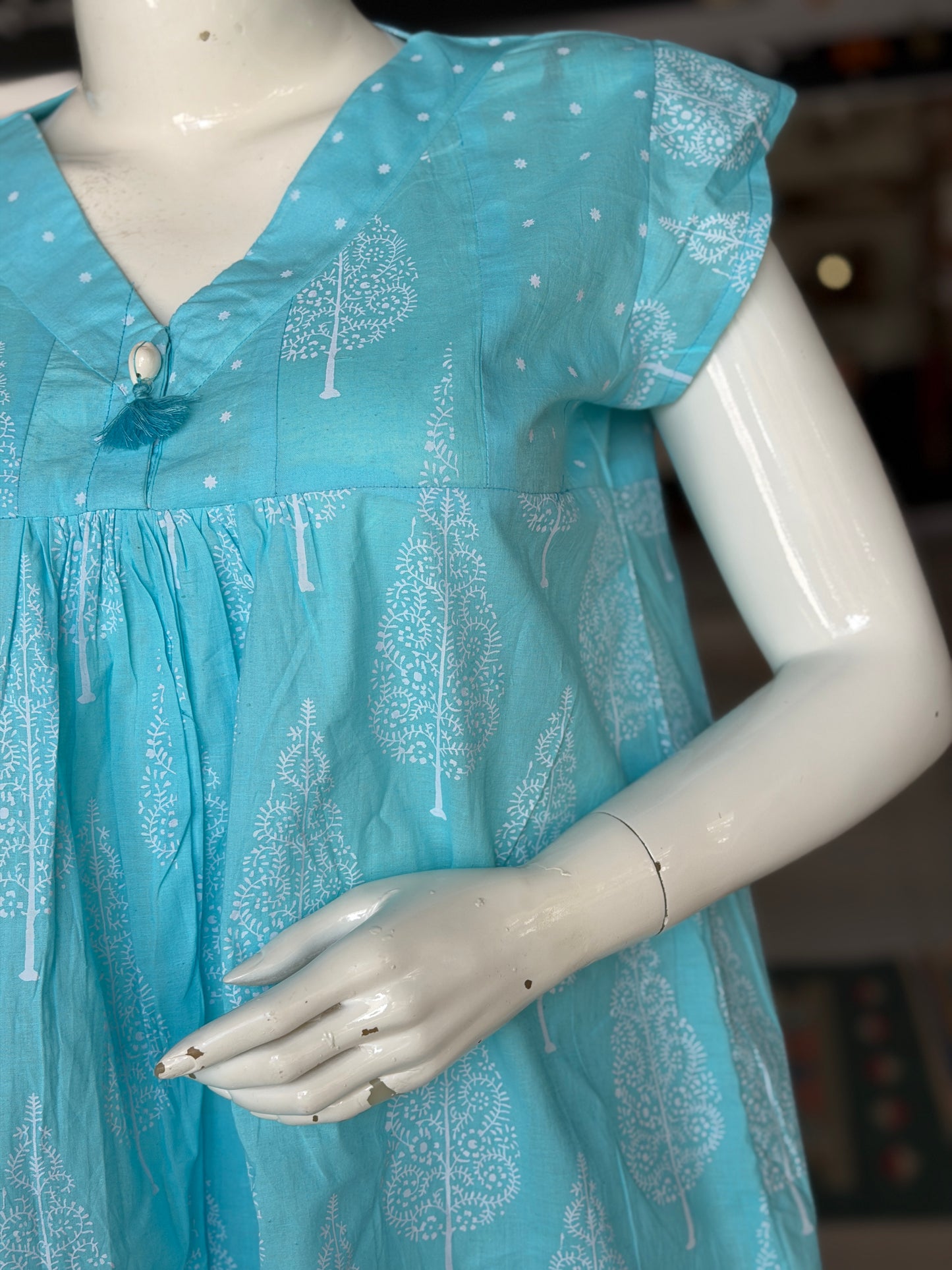 Blue dots and cypress print pleated cotton top with cowrie shell button