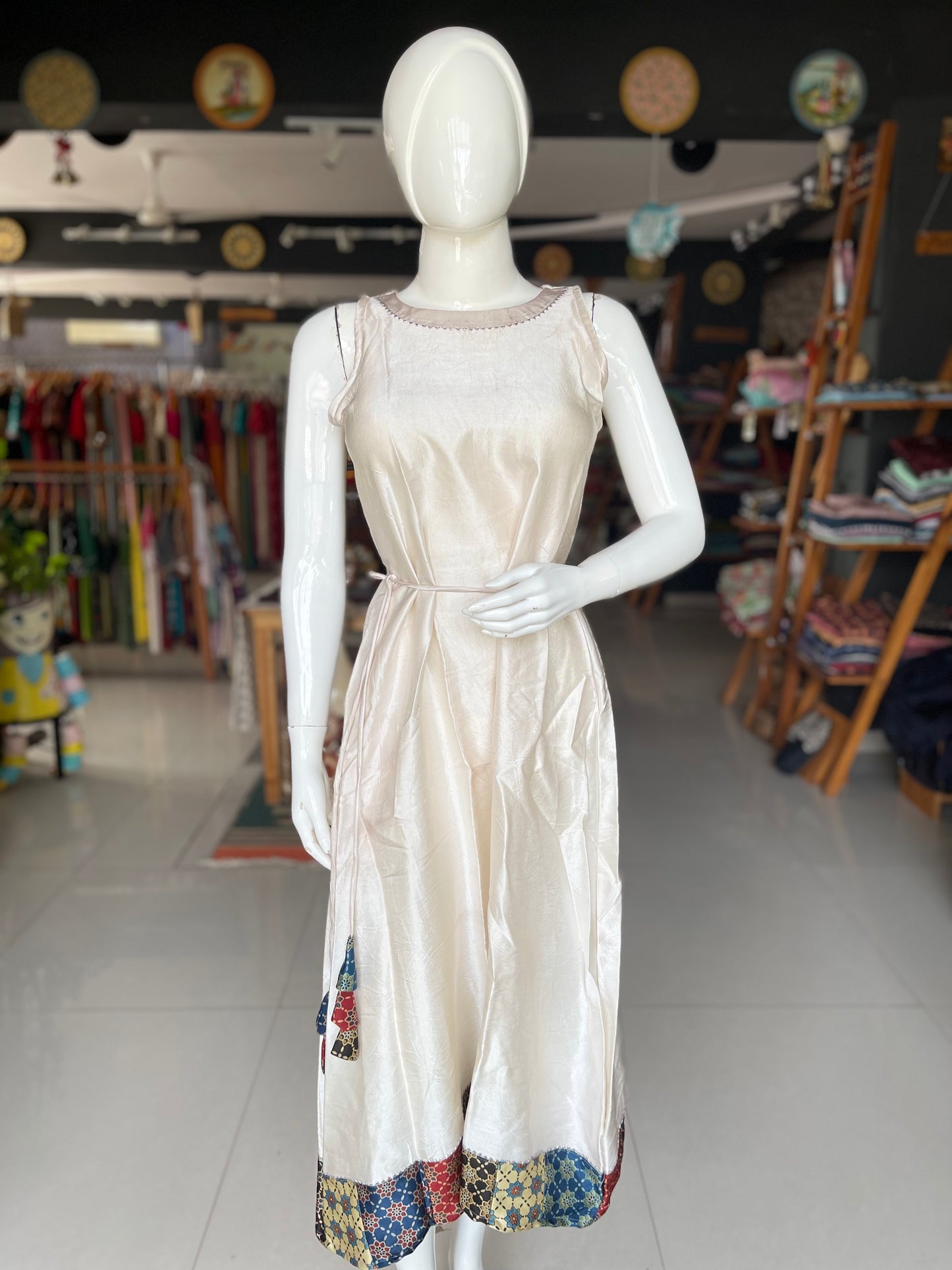 Mashru plain sleeveless dress with Ajrakh hand block printed patch border and tassles belt