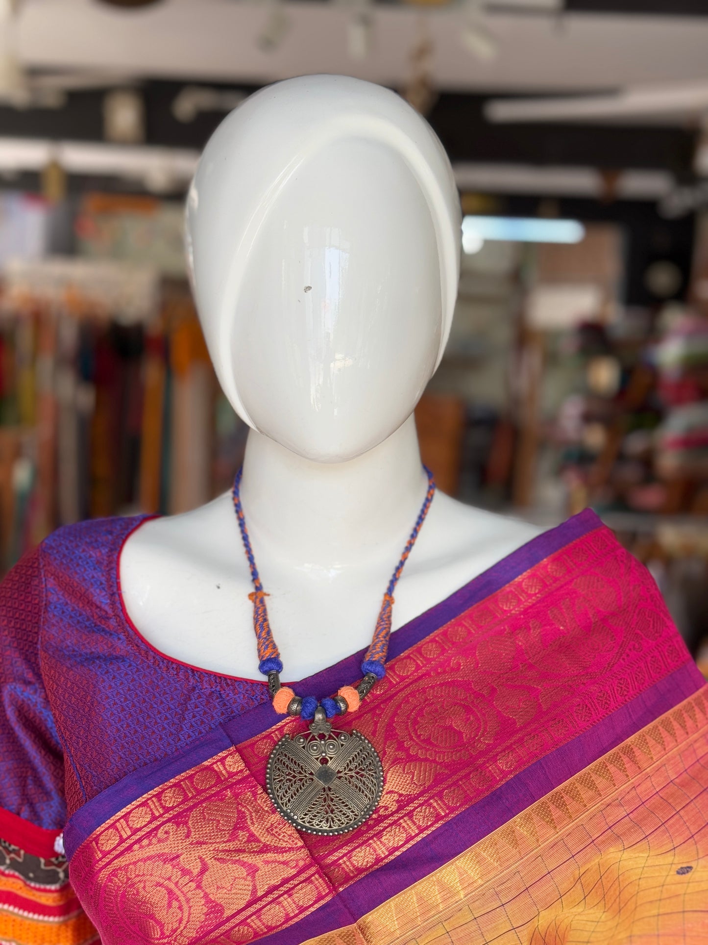 Orange and blue thread with circular pendant oxidised neckpiece