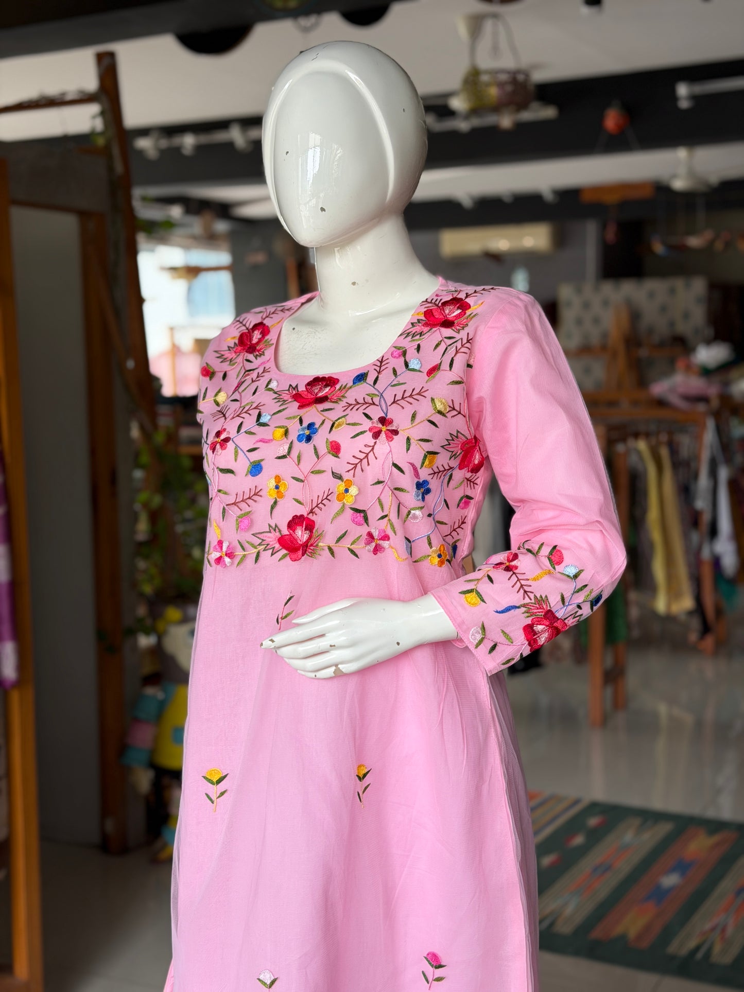 Pink hand embroidered floral design a-line net kurti