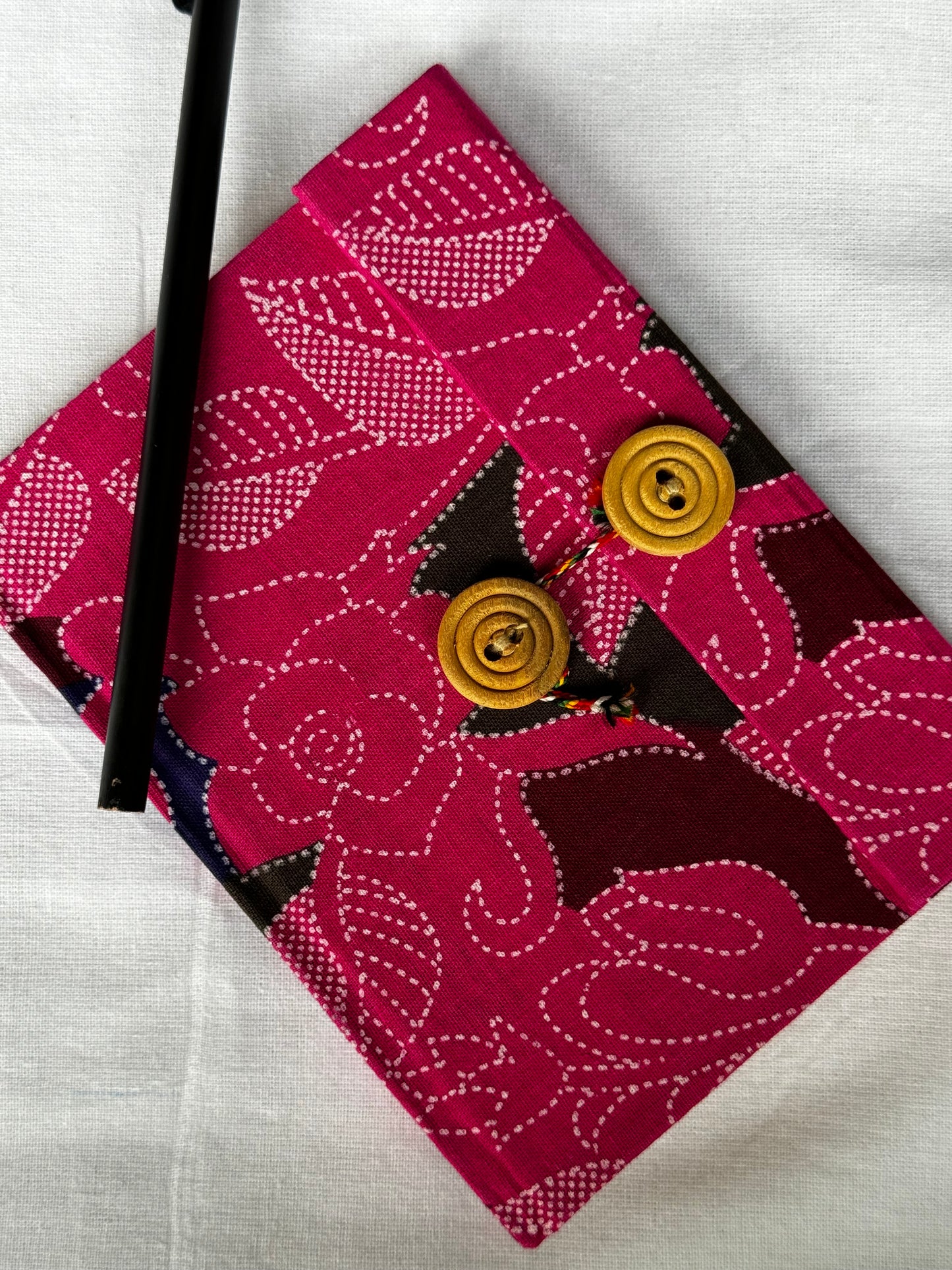 Pocket notebook with fabric cover with button and thread closure