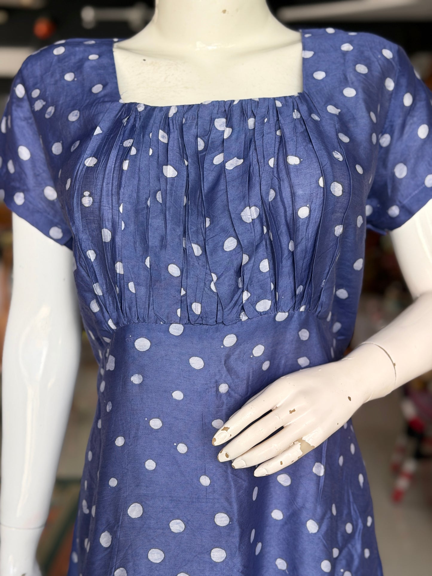 Blue polka dots dress with square neckline and gathered bust