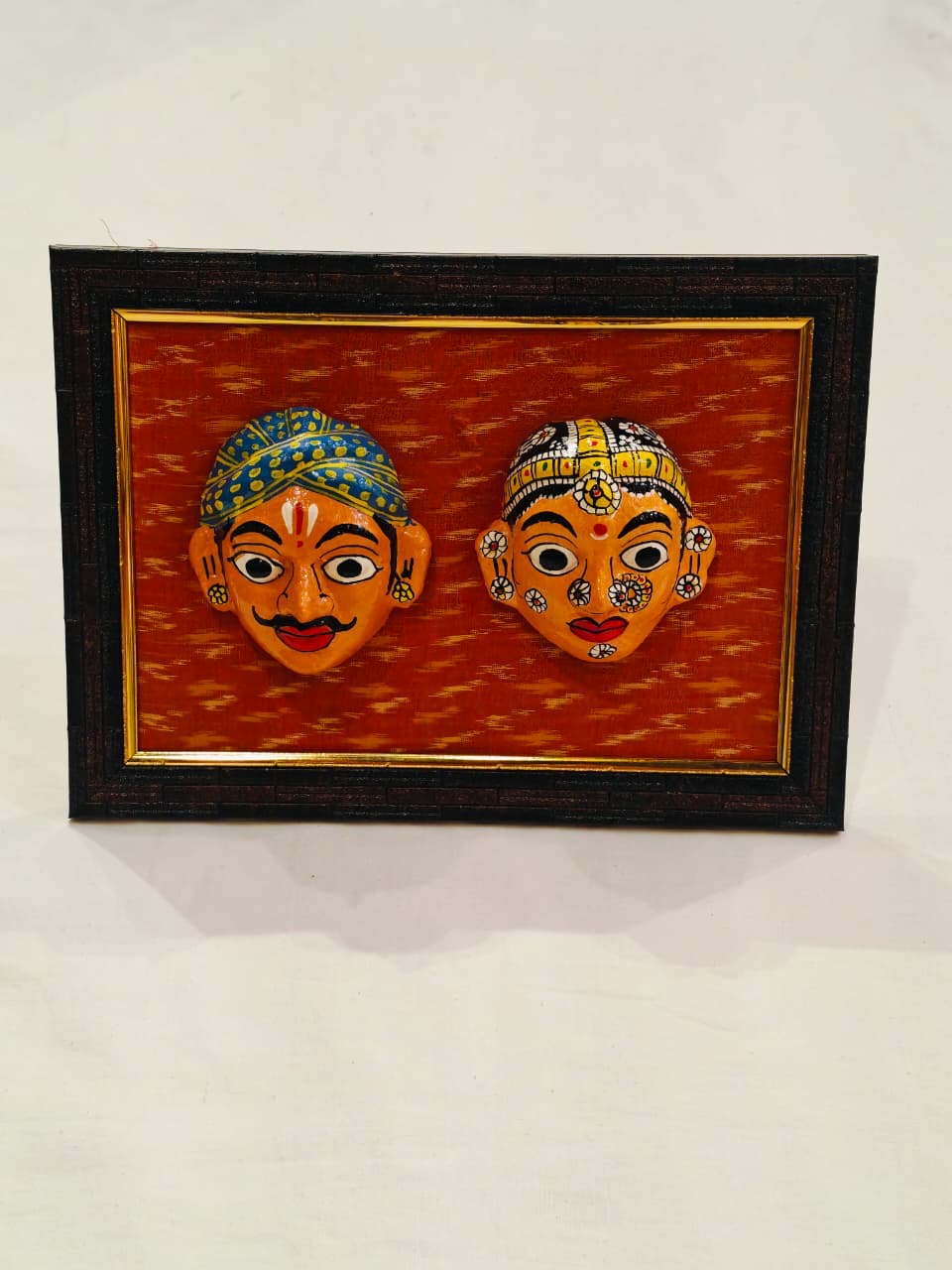 Cheriyal man and woman handcrafted masks pair on ikat background wall frame