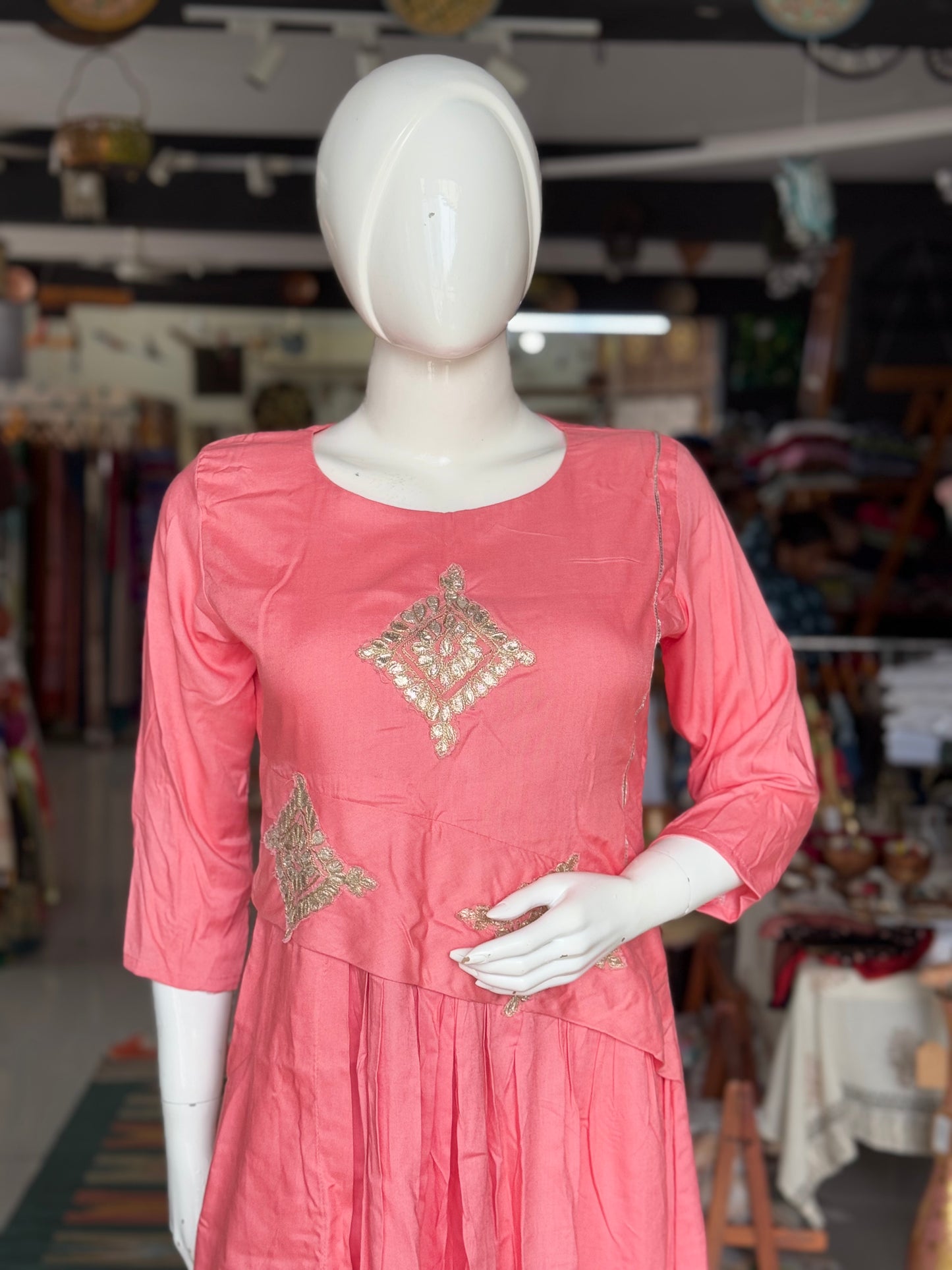 Peach soft rayon designer dress with low pleats and gota detailing