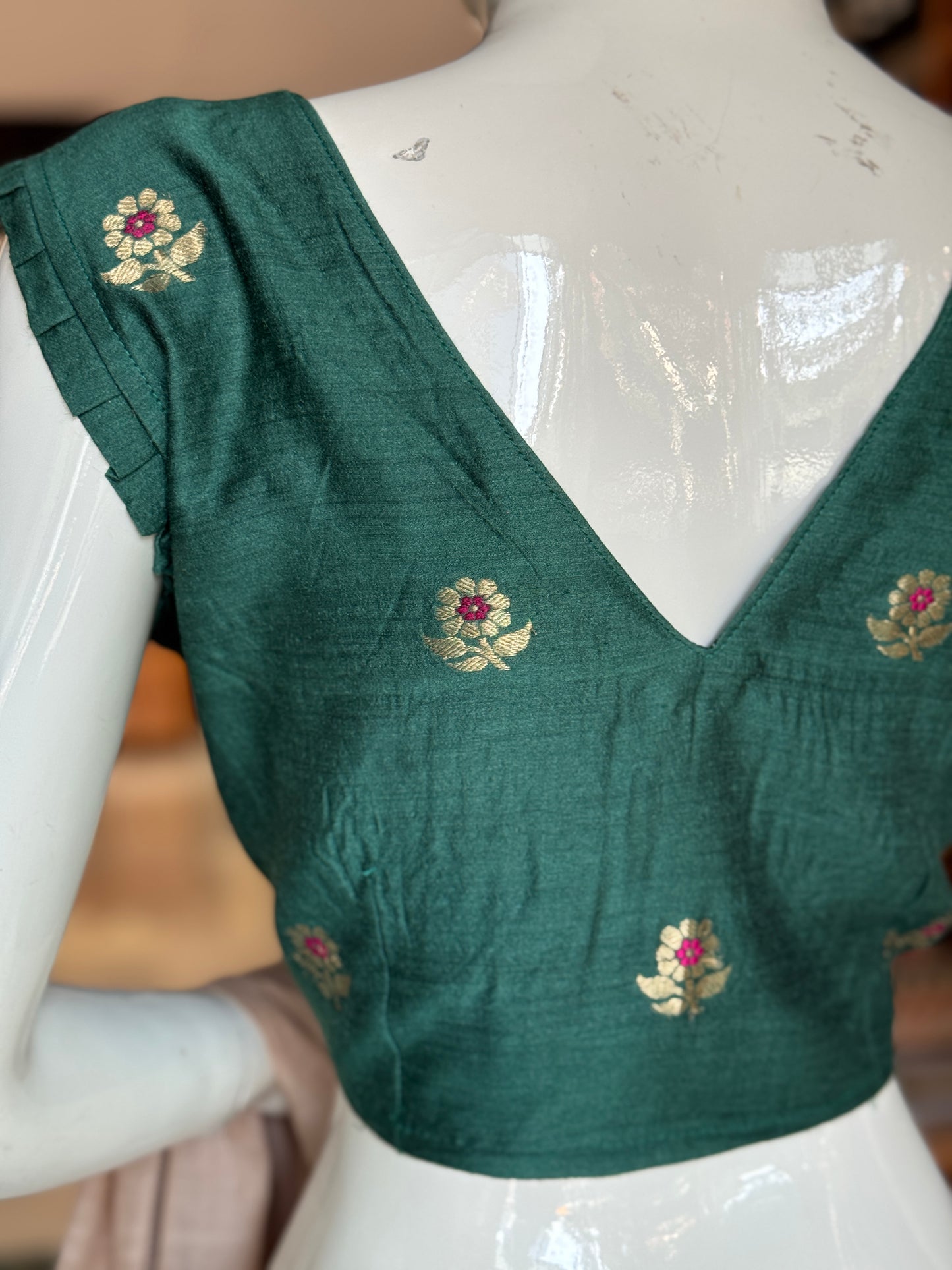 Teal green moonga silk handwoven blouse with floral motifs