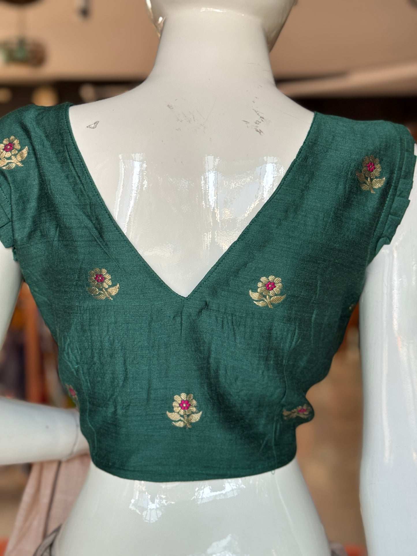 Teal green moonga silk handwoven blouse with floral motifs