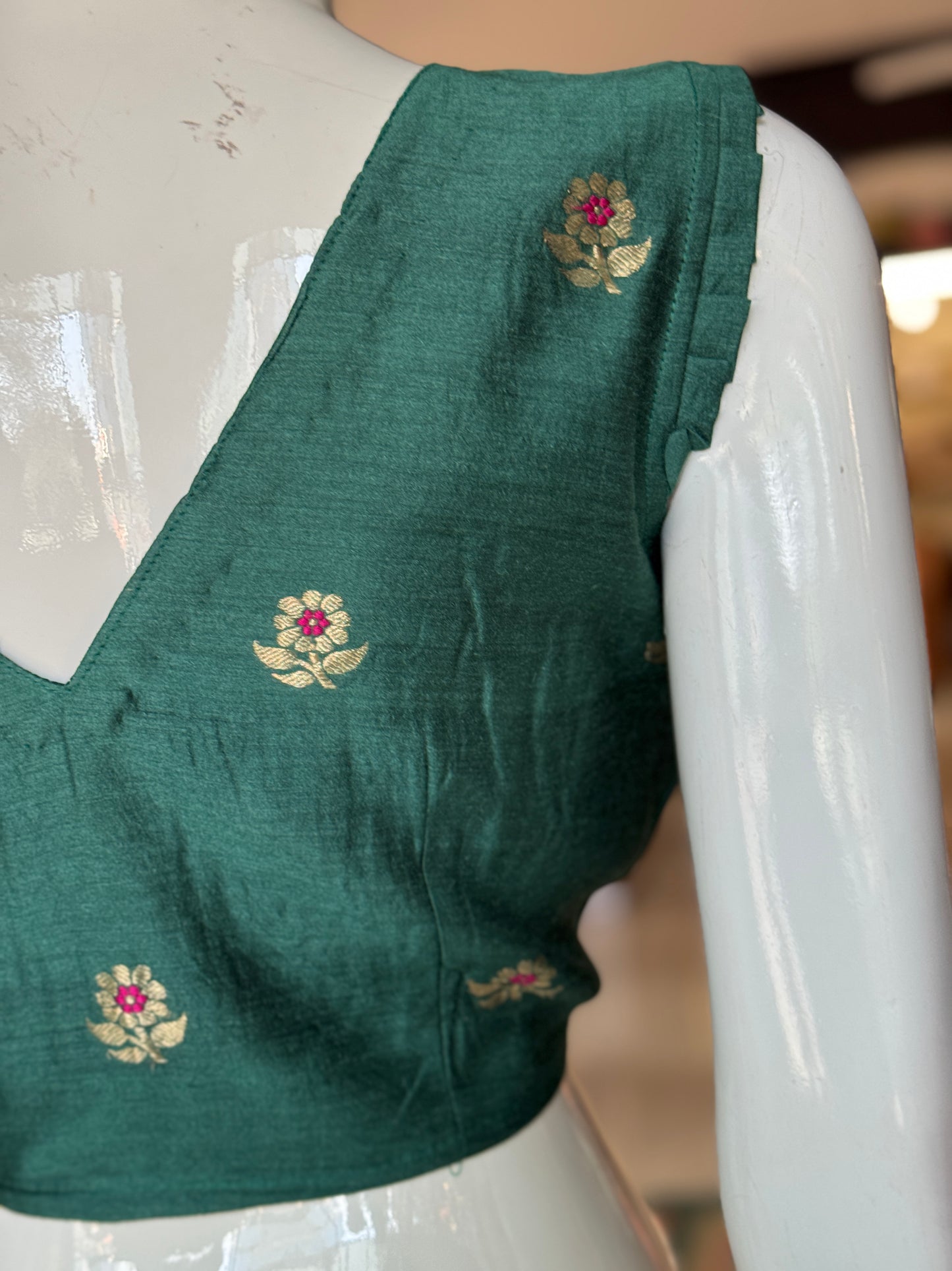 Teal green moonga silk handwoven blouse with floral motifs