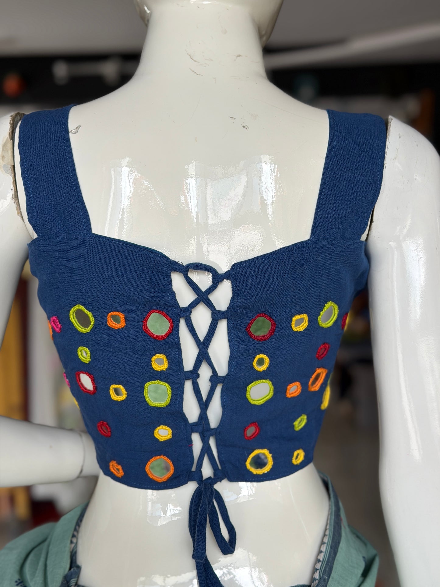 Navy blue kala cotton sleeveless blouse with all over colorful mirror work on front and back with adjustable width back