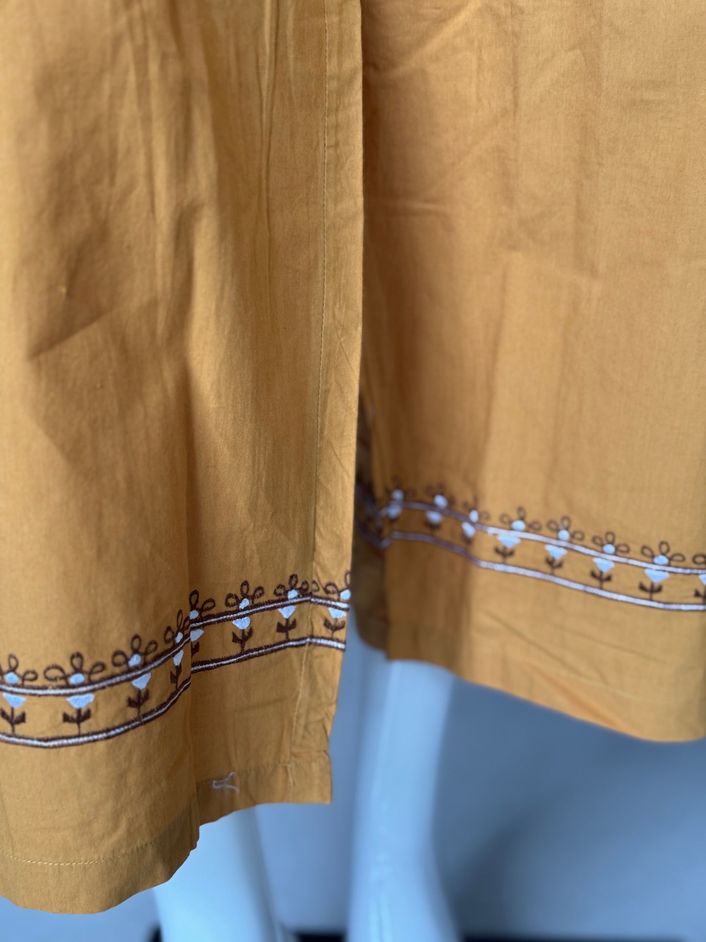 Mustard cotton pants with embroidery detailing at hem line