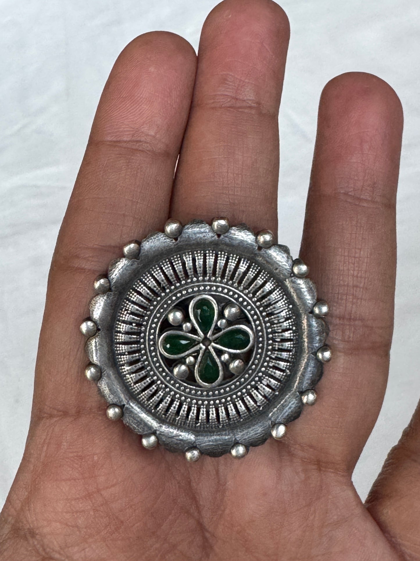 Green stones in the center - oversized brass finger ring with silver finish