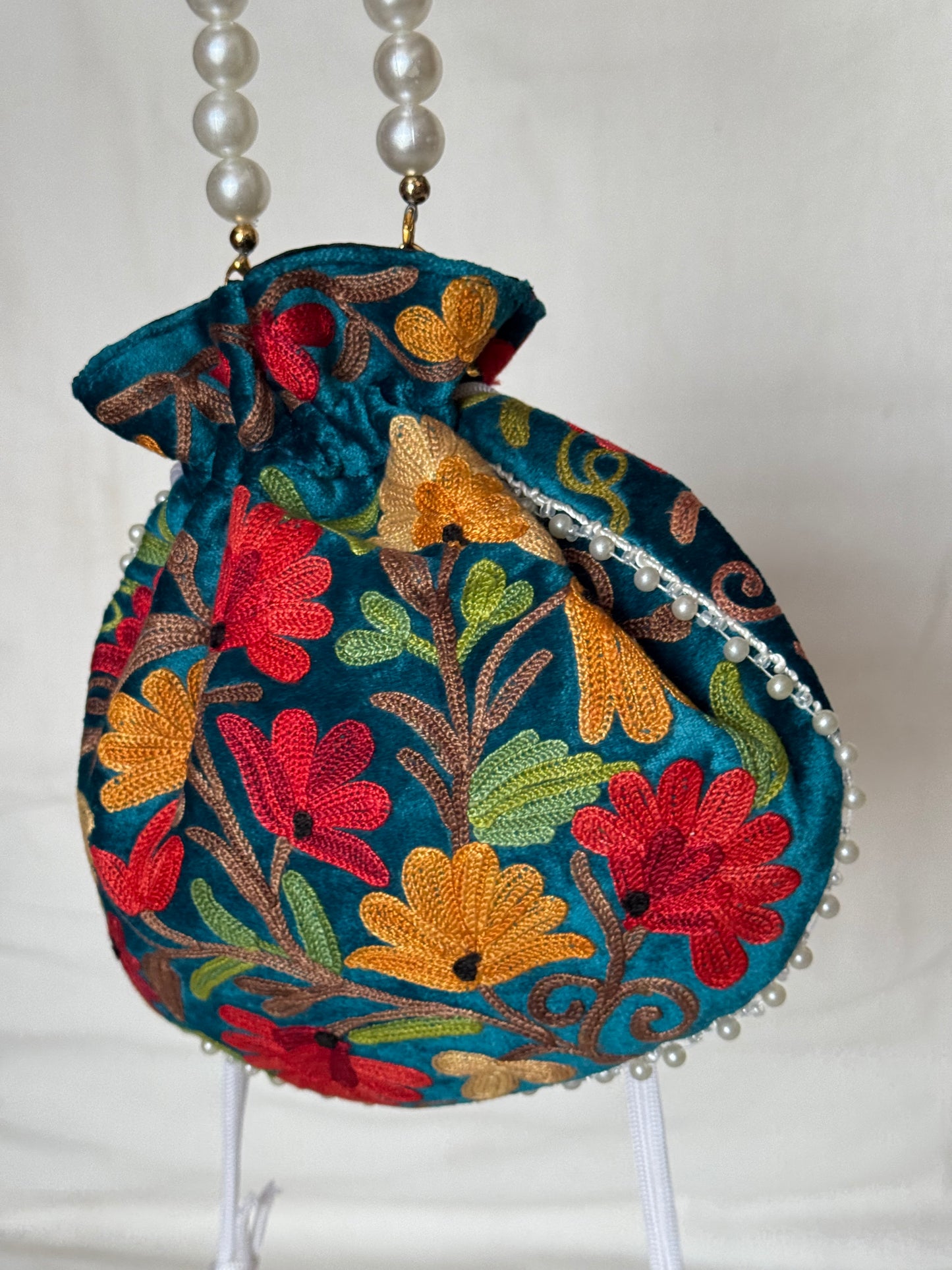 Round Potli bag with Kashmiri floral Aari embroidery - drawstring closure