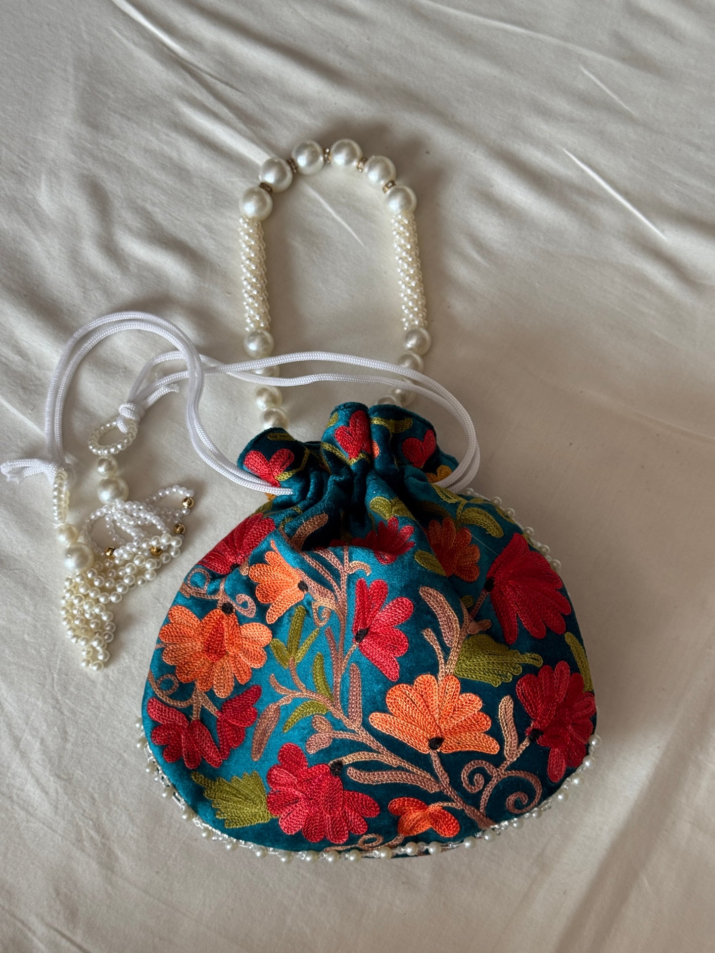 Round Potli bag with Kashmiri floral Aari embroidery - drawstring closure