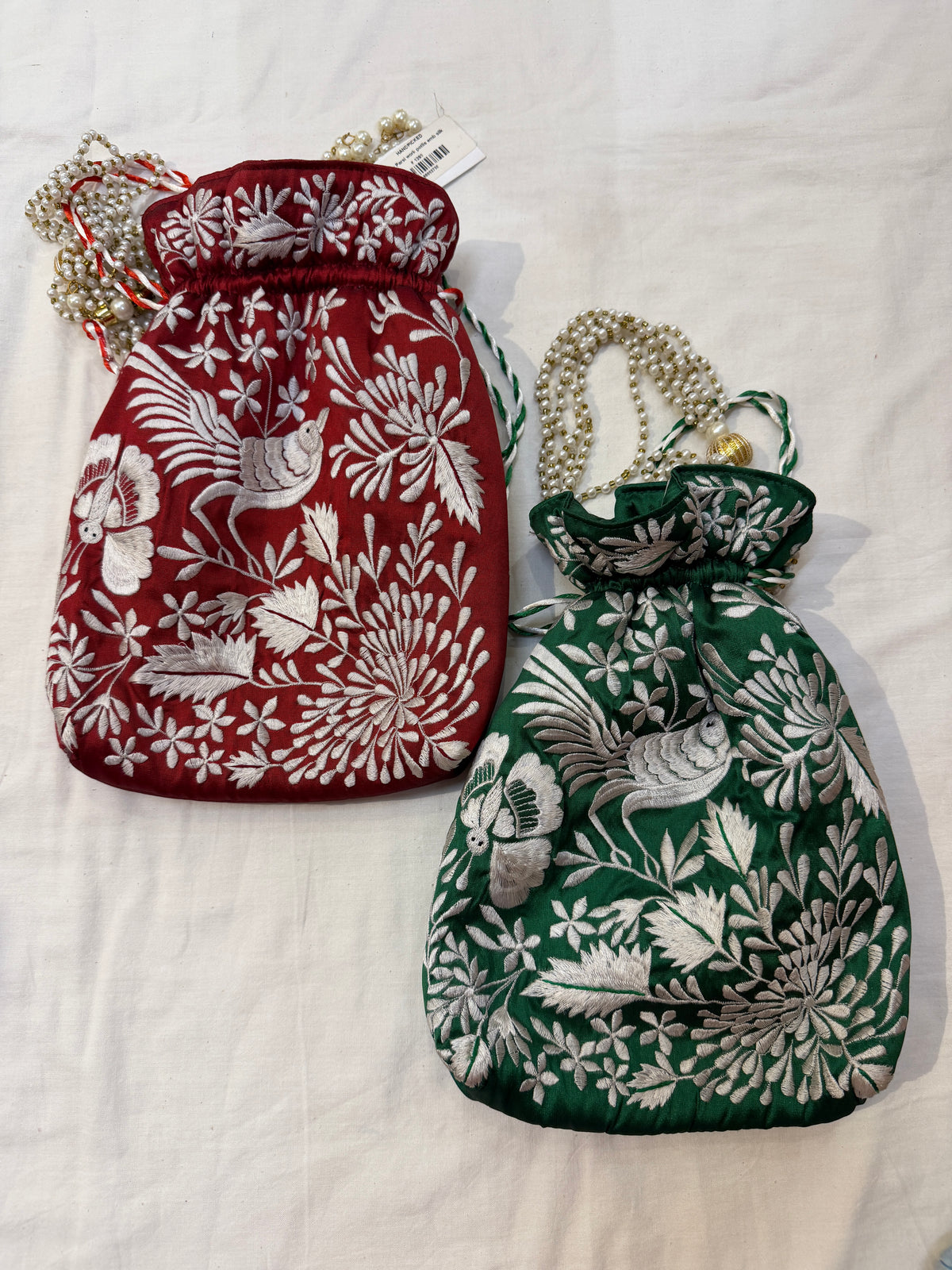 Parsi work party wear potlis with machine embroidery on art silk and pearl chain handle
