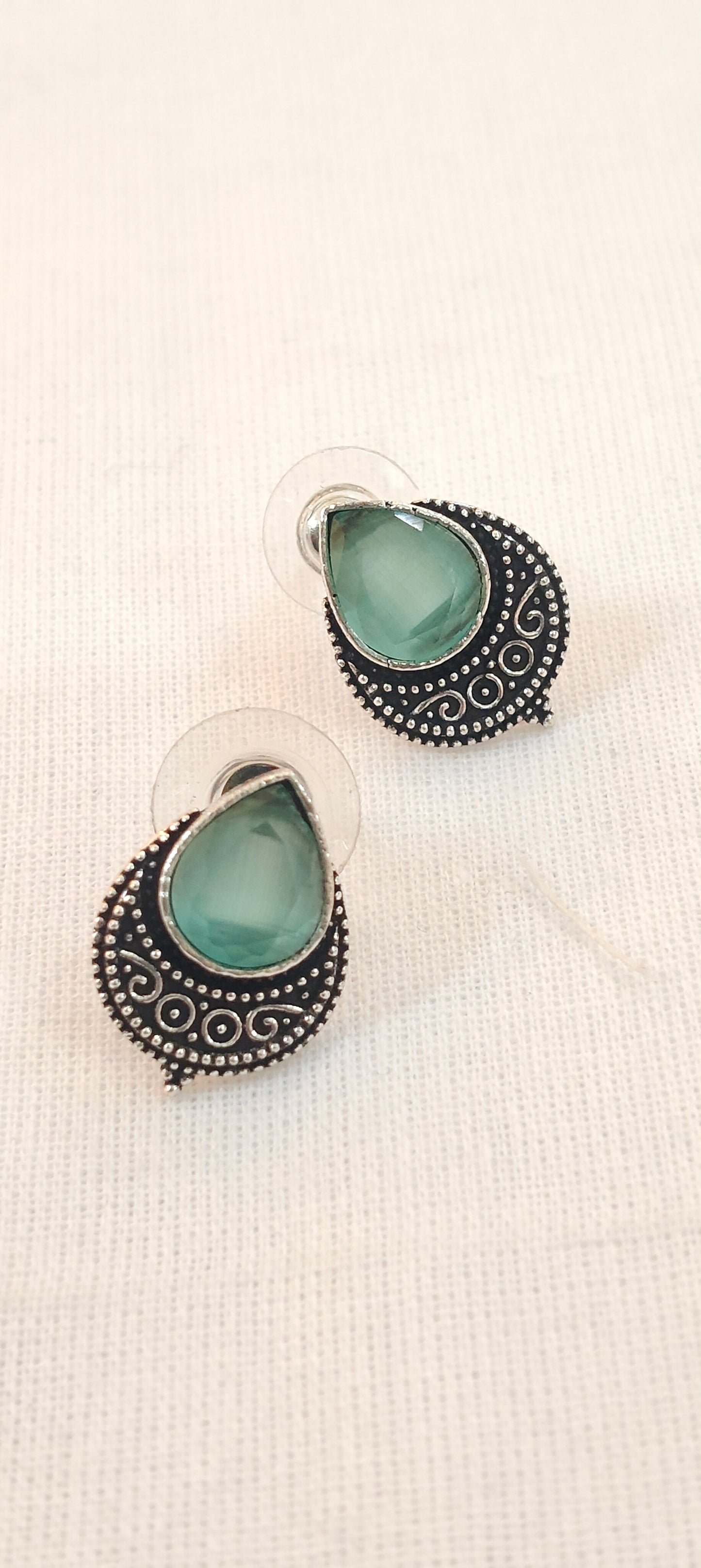 Mint green drop shaped stone stud earrings with silver detailing