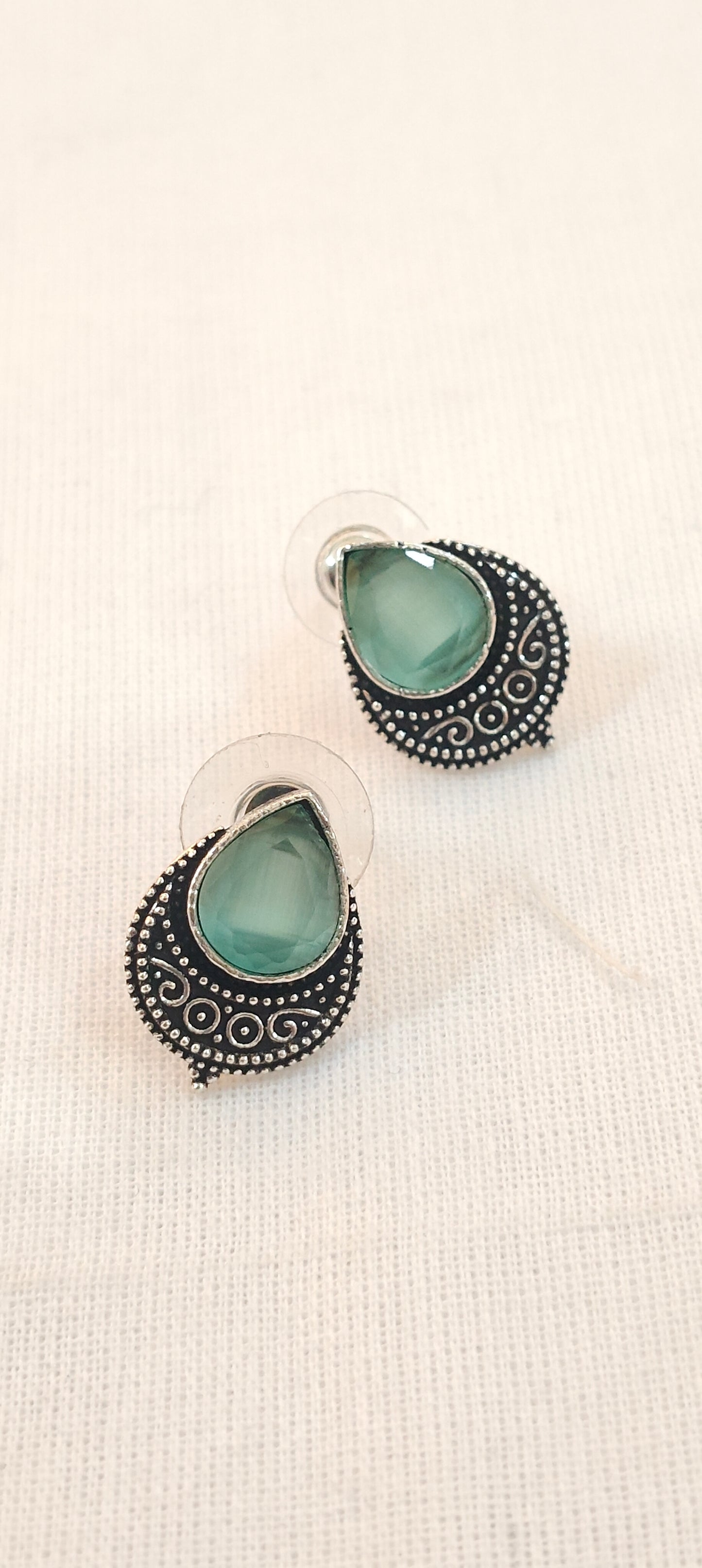 Mint green drop shaped stone stud earrings with silver detailing