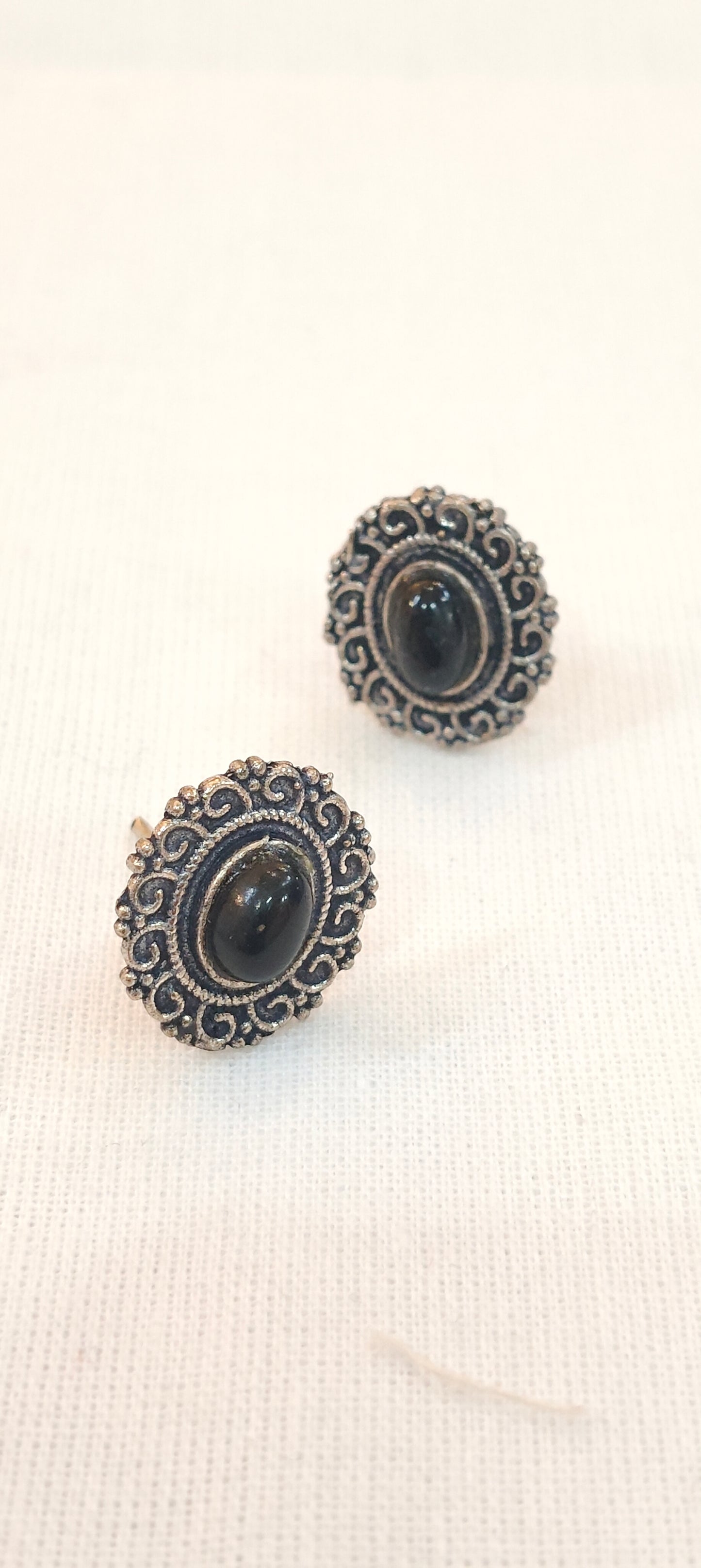 Black stone oval shaped stud earrings with oxidised silver detailing