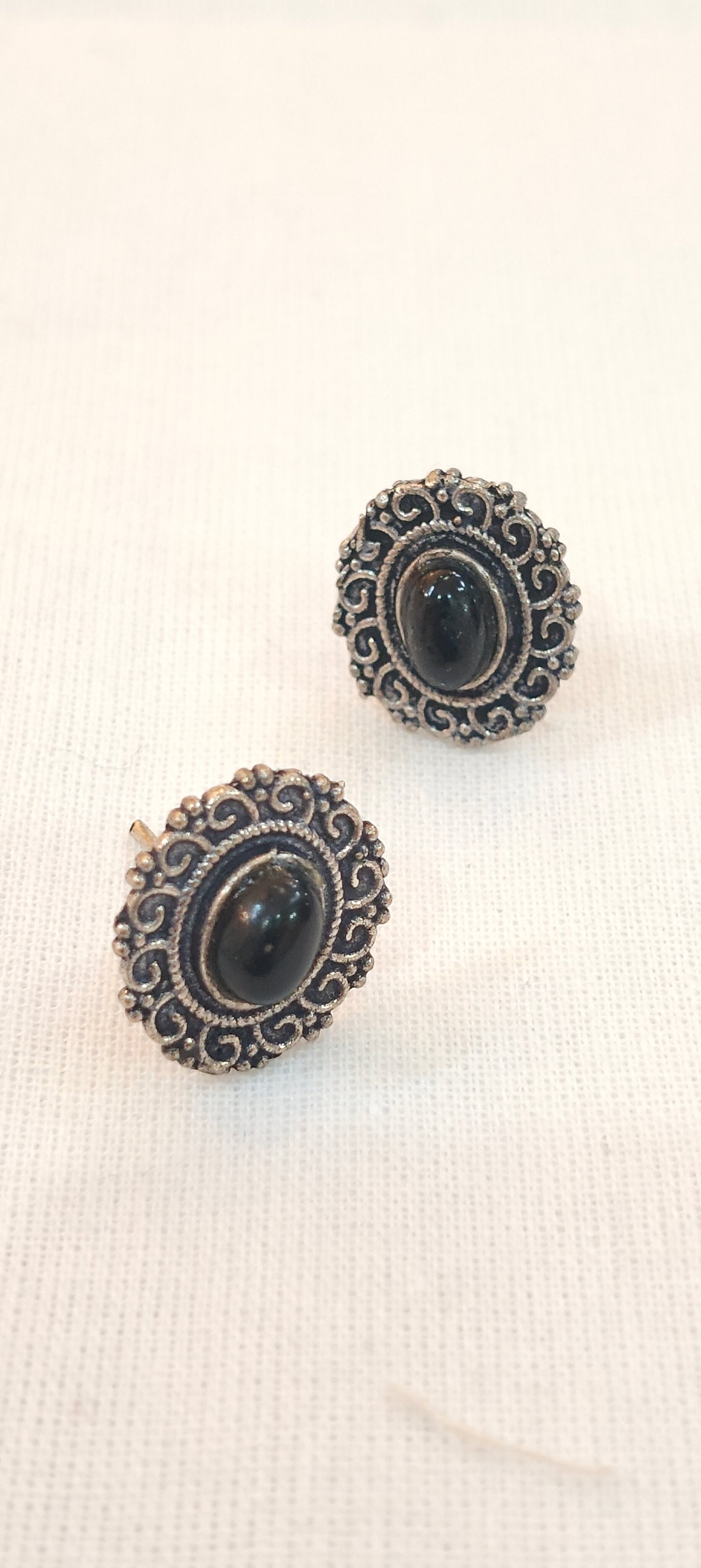 Black stone oval shaped stud earrings with oxidised silver detailing