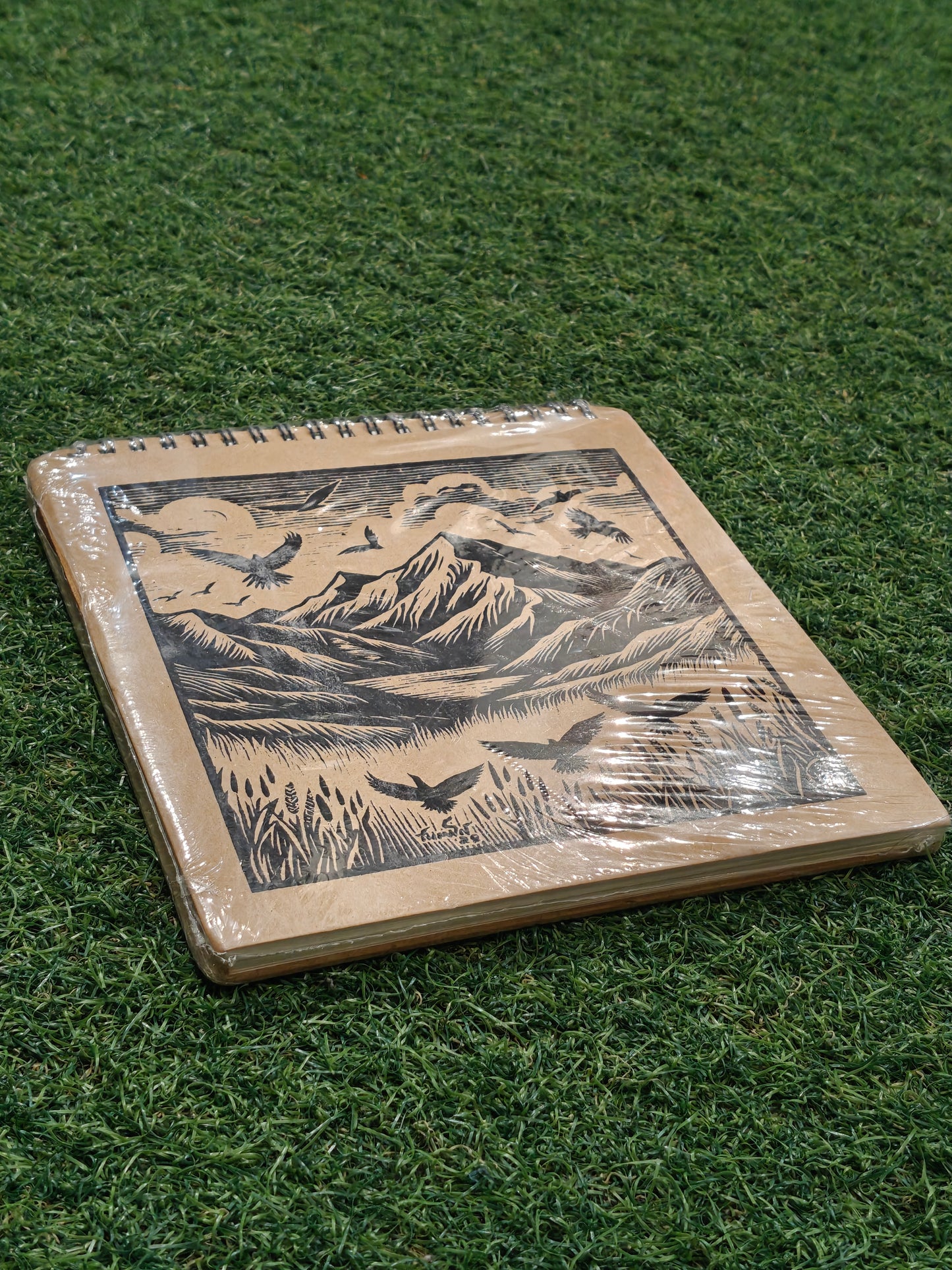 Hand made paper sketchbook with brown board cover and spiral binded