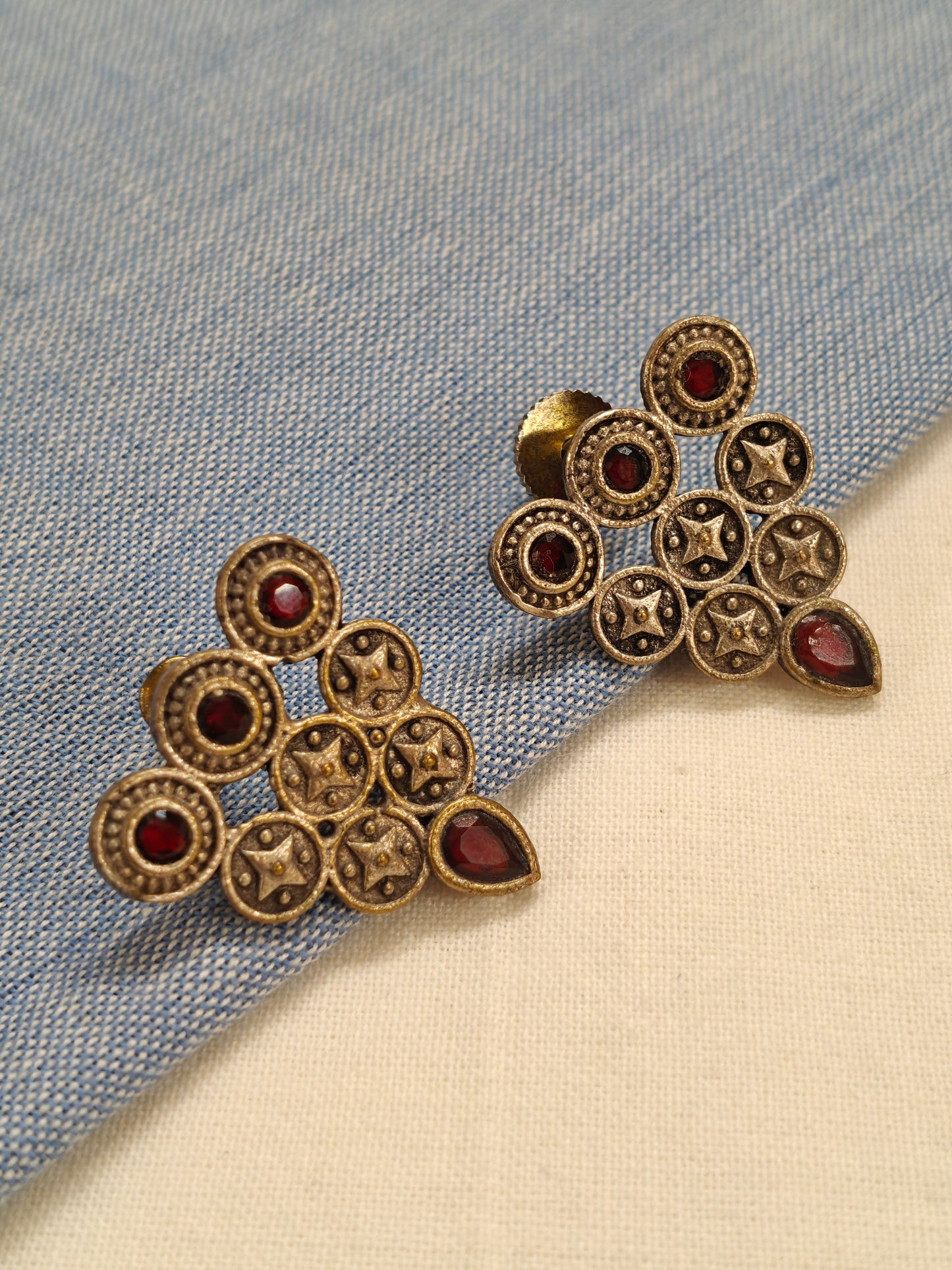 Triangle made by circles with red stones oxidised silver ear studs
