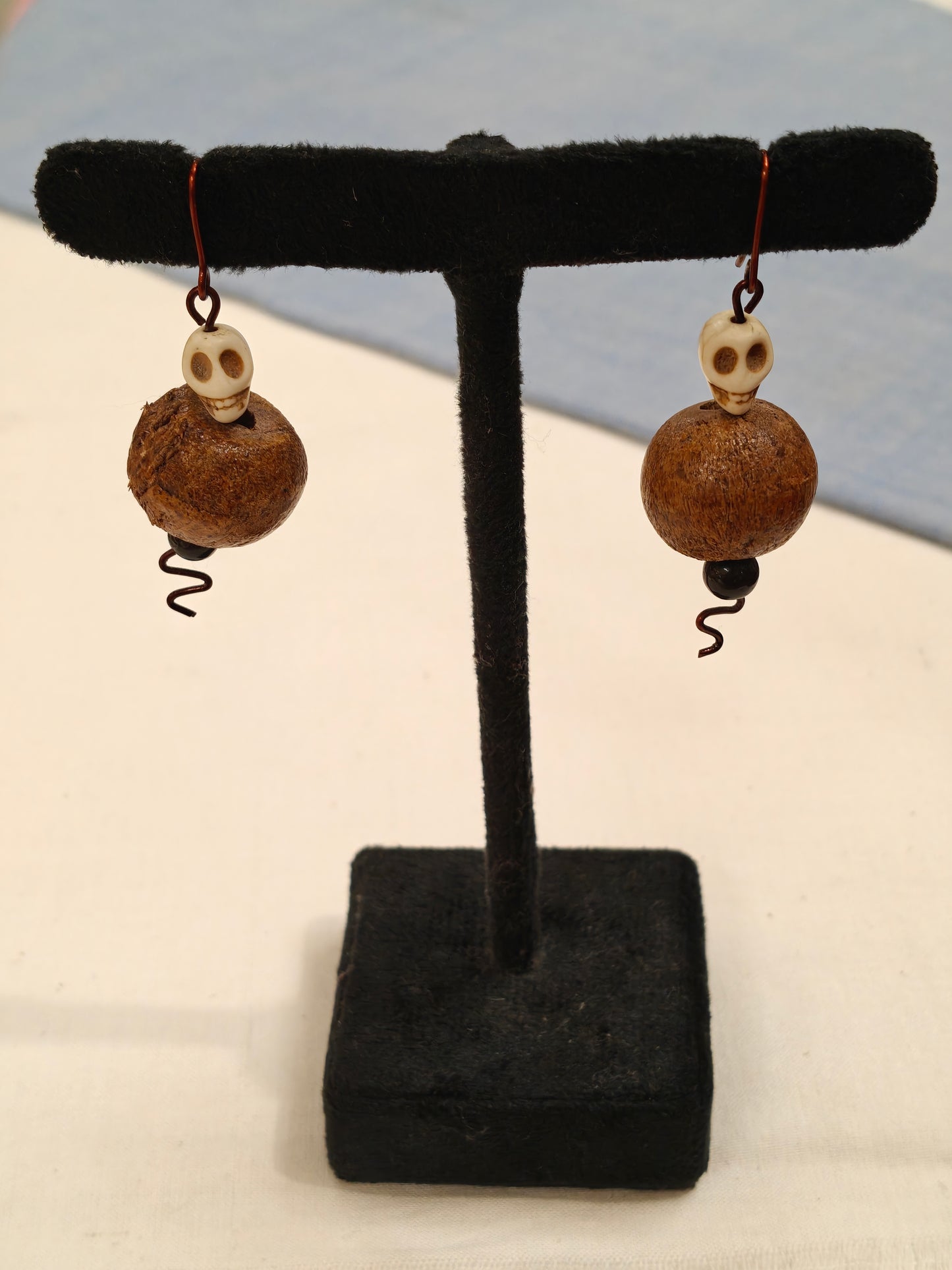 Earrings with wooden bead and skull shaped bead ear hooks