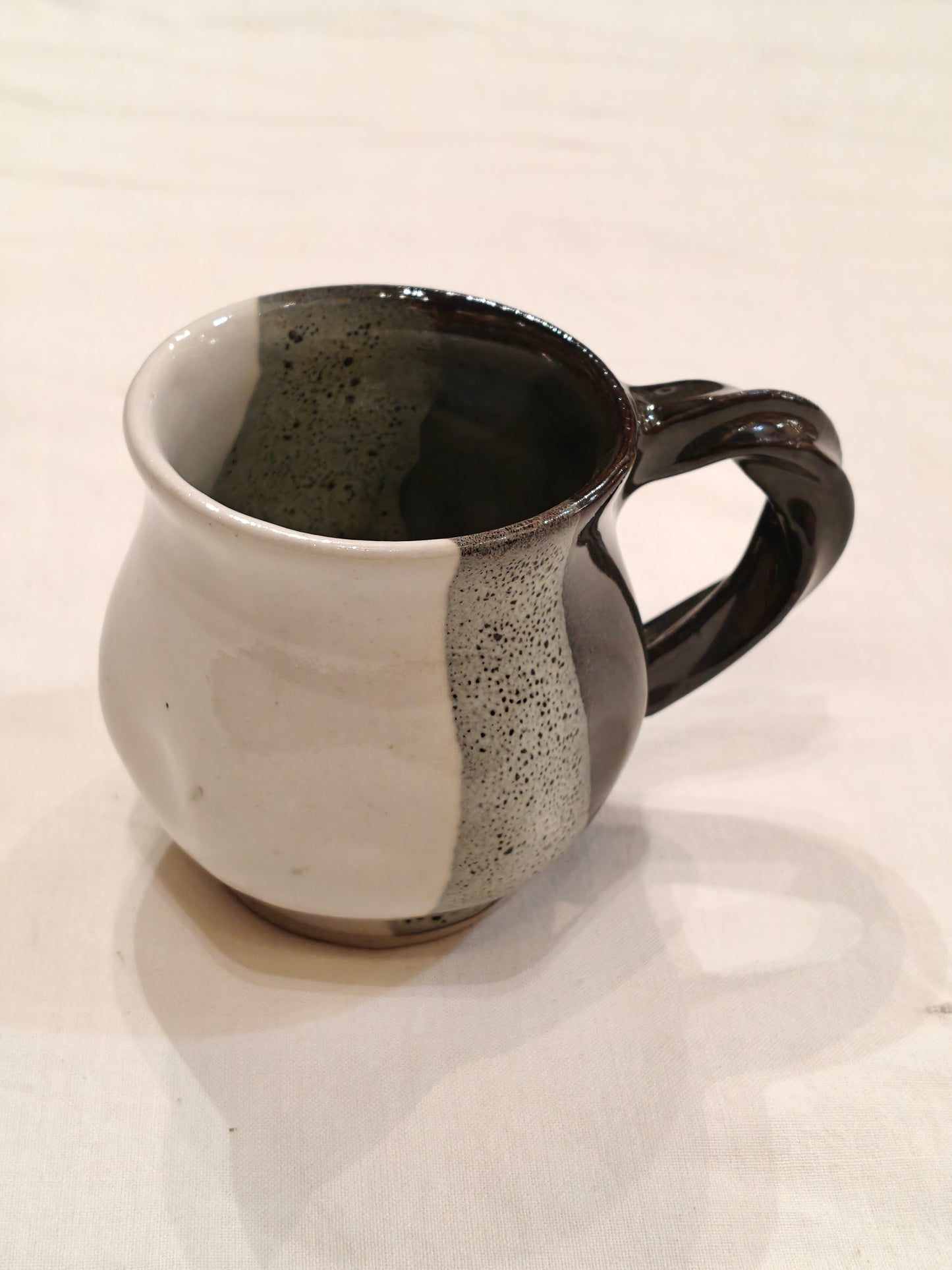 Ceramic white,green and black vertical bands with twisted handle Handcrafted cup
