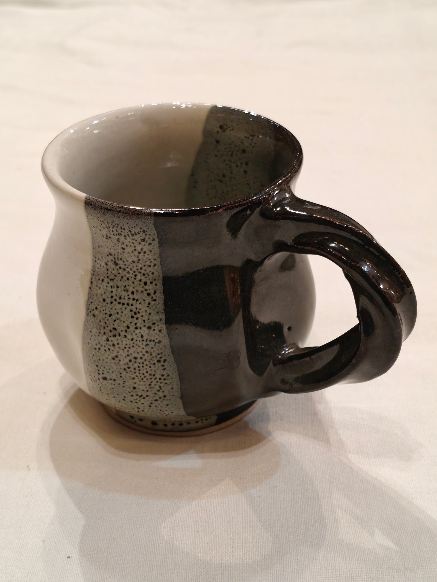 Ceramic white,green and black vertical bands with twisted handle Handcrafted cup