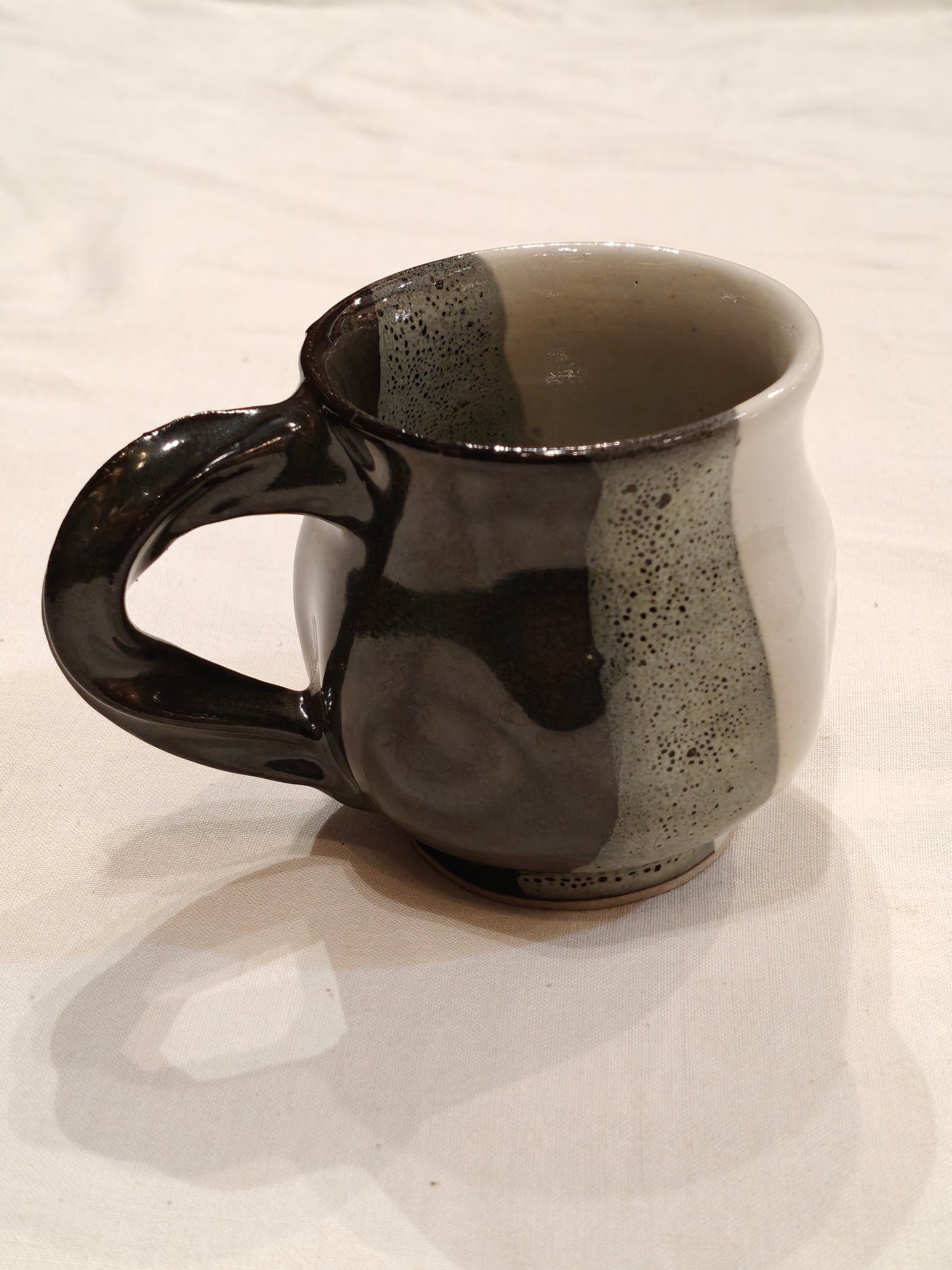 Ceramic white,green and black vertical bands with twisted handle Handcrafted cup