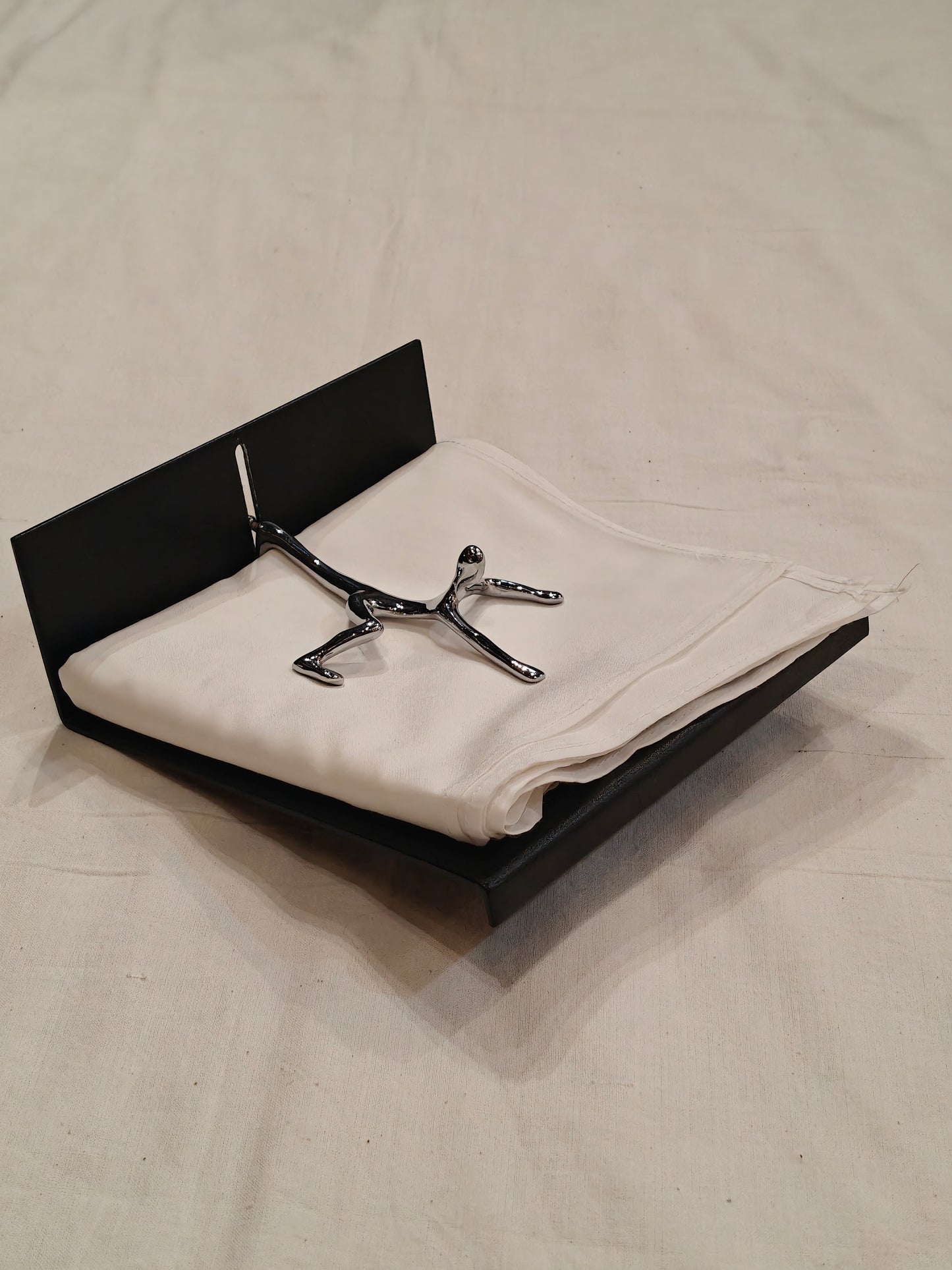 Quirky napkin holder - man all over the place to save your tissues from flying off
