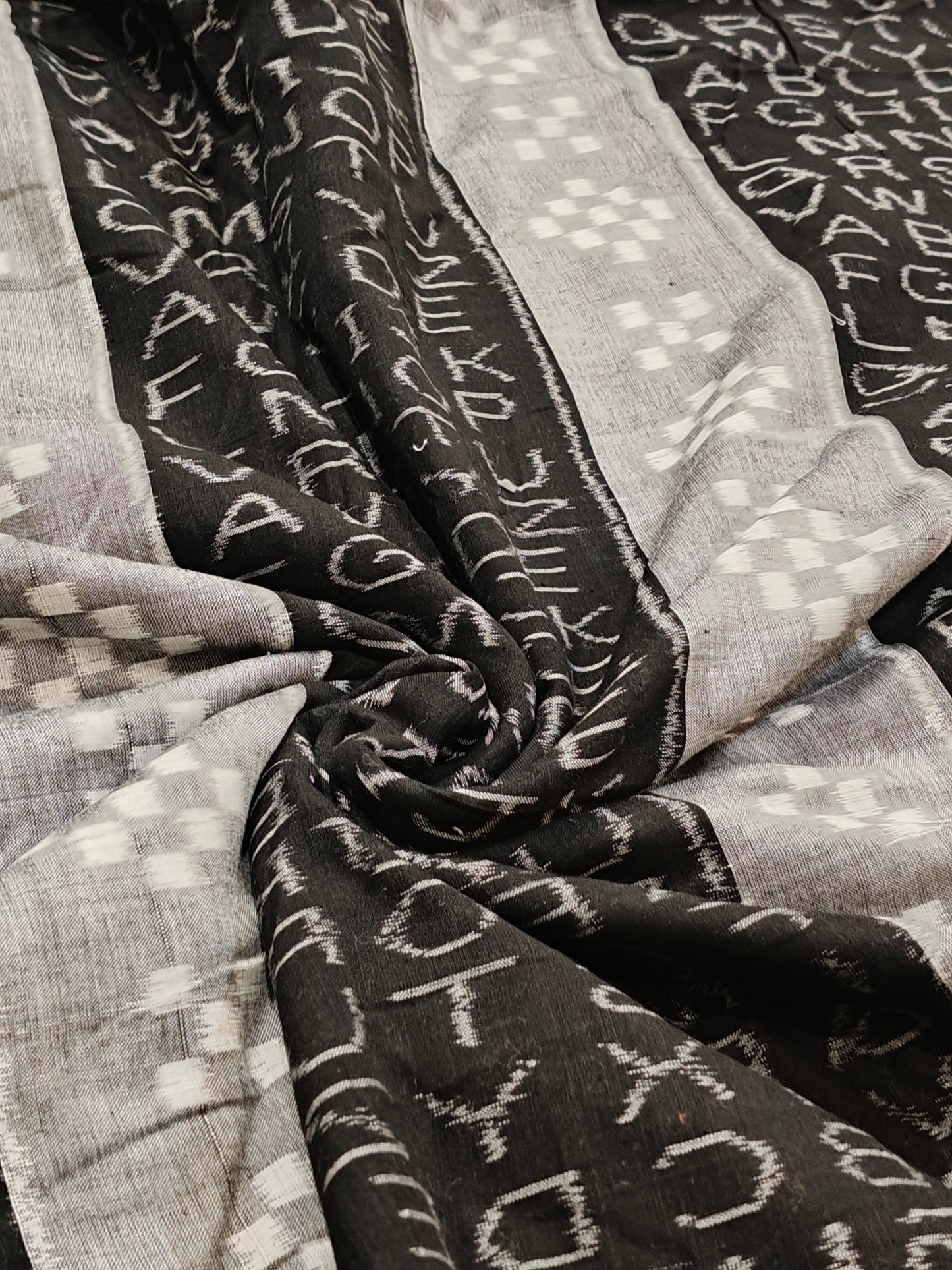 Black and grey alphabets design ikat tie and dye handloom cotton fabric