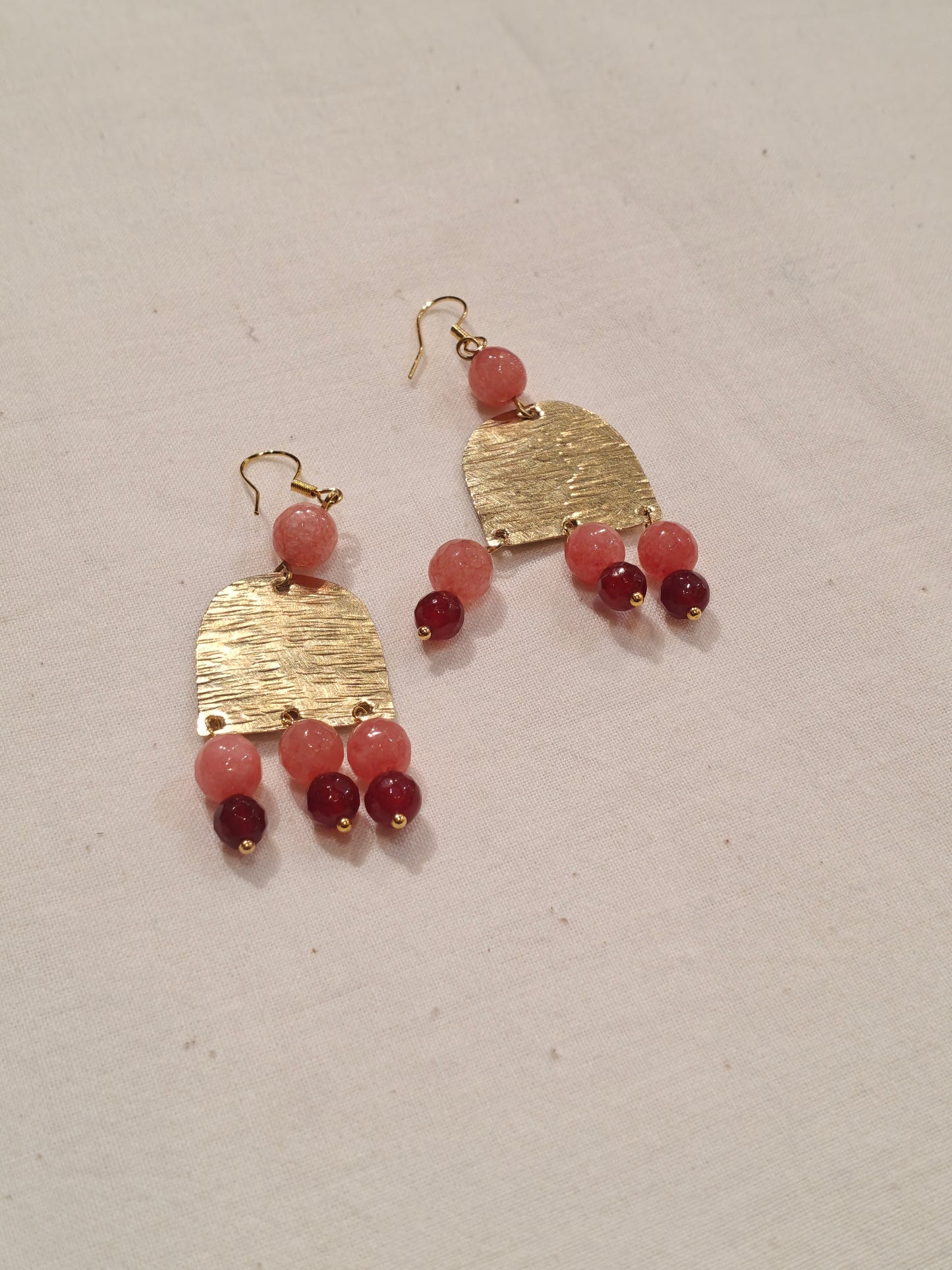 Long semi-circular brass handcrafted hook earrings with peach and red beads